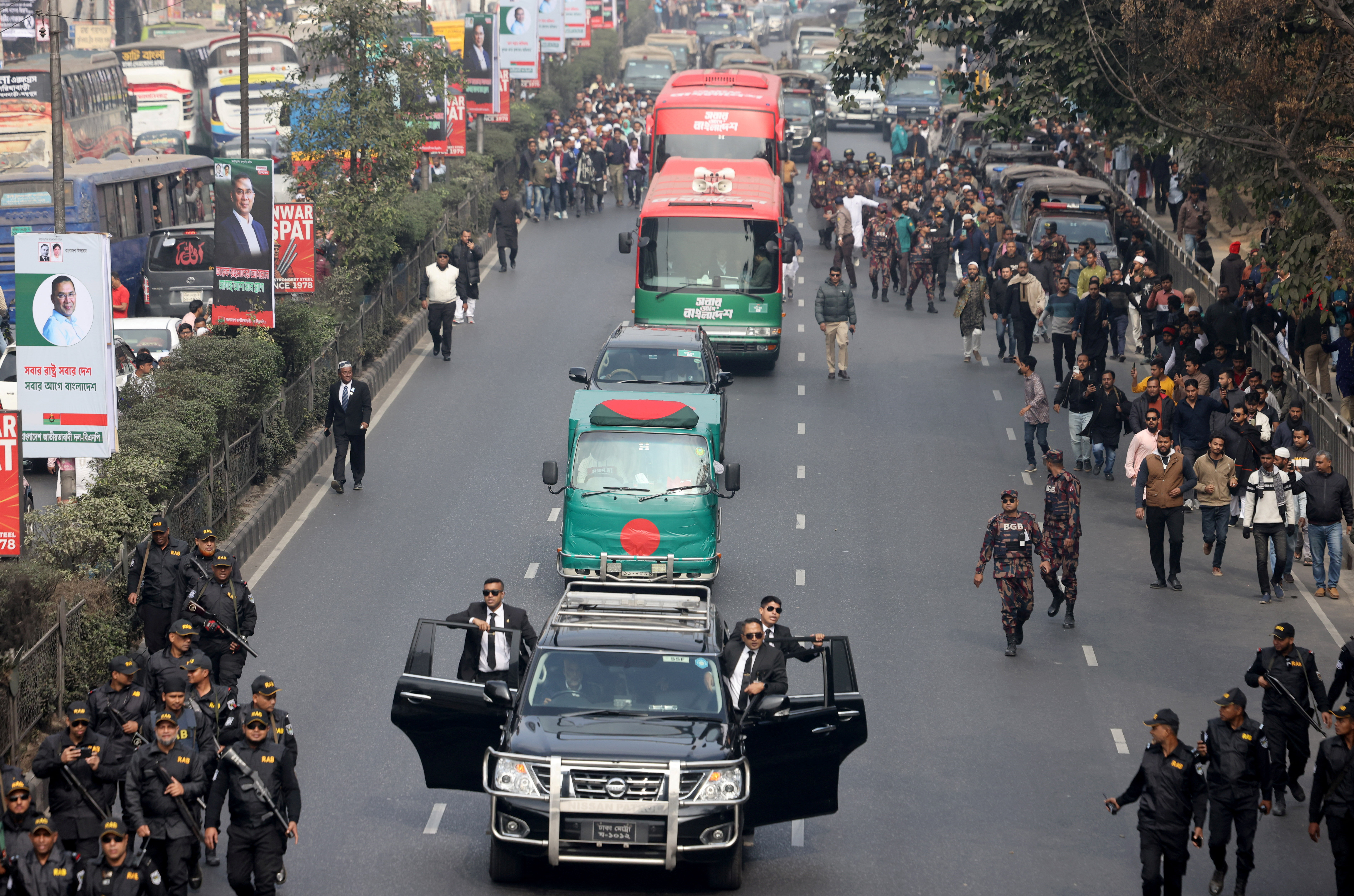 Security forces escort a flag-draped vehicle carrying the body of Bangladesh's former Prime Minister Khaleda Zia in a convoy for her funeral in Dhaka.