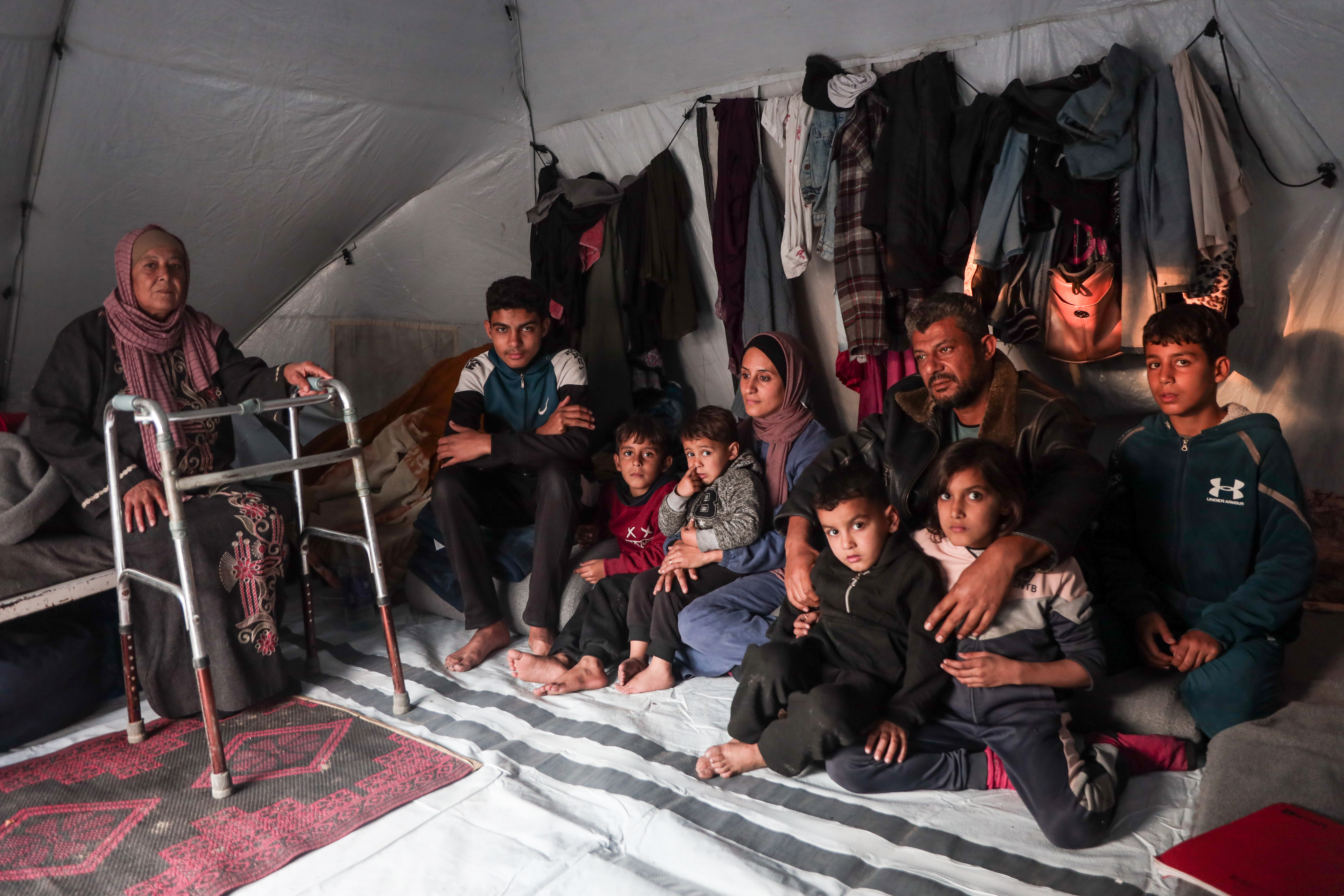 Alaa Alzanin family gathering in the small tent sheltering them in Gaza City