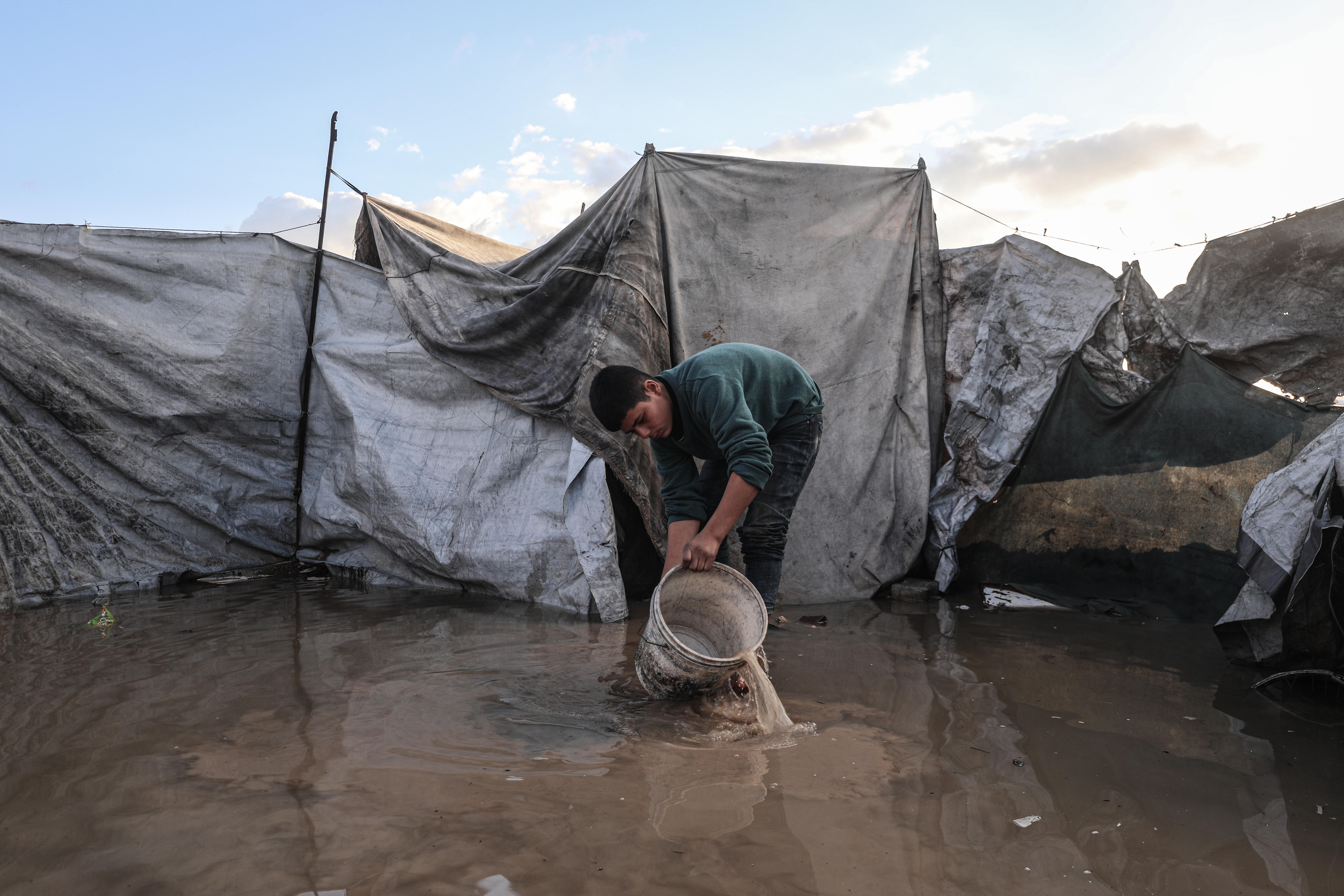 Flooding hits displaced Palestinians’ tents after heavy rain in Gaza