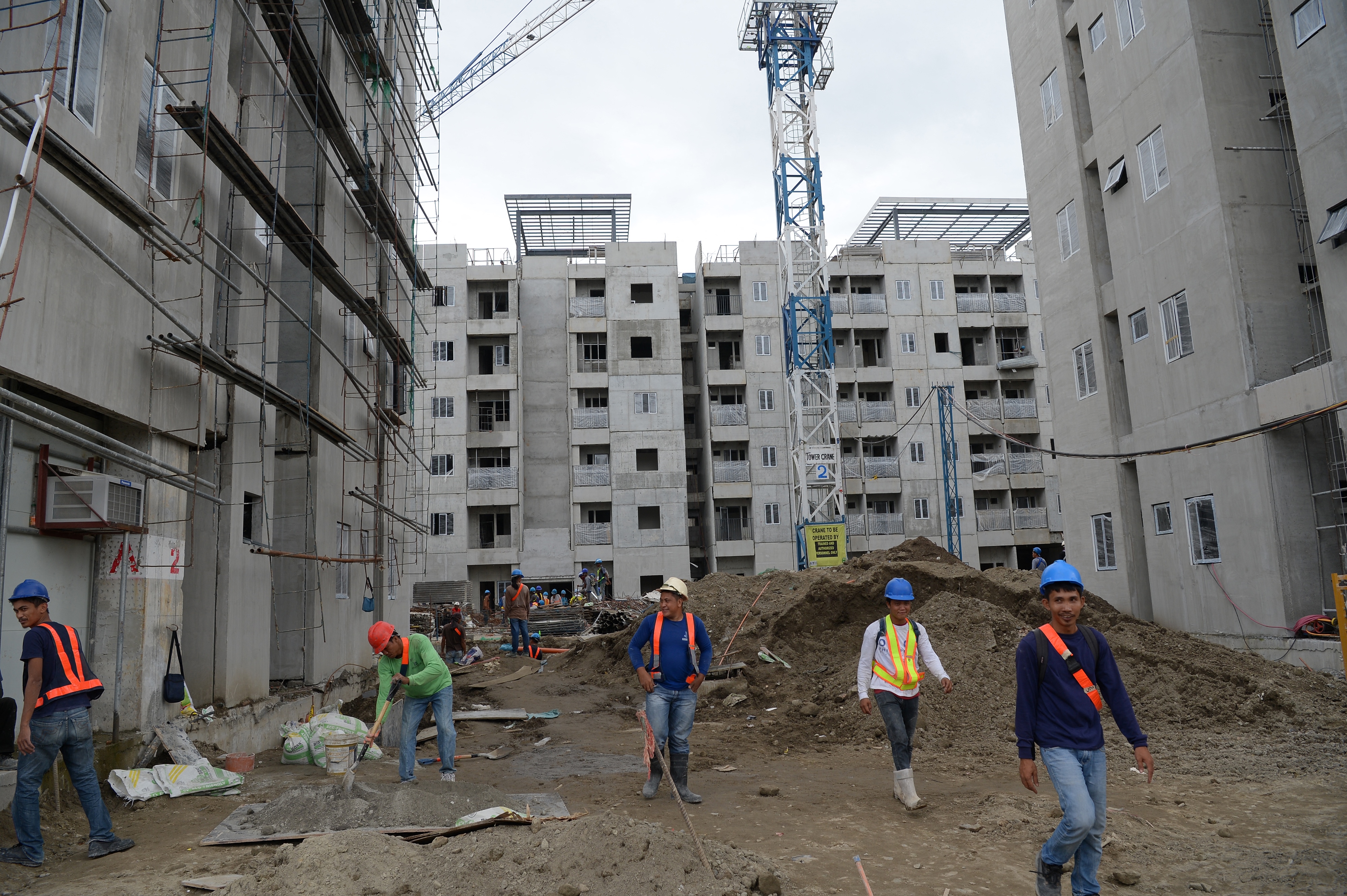 Labourers work on buildings in the games village for this year's Southeast Asian Games (SEA Games) in New Clark City in Capas town.