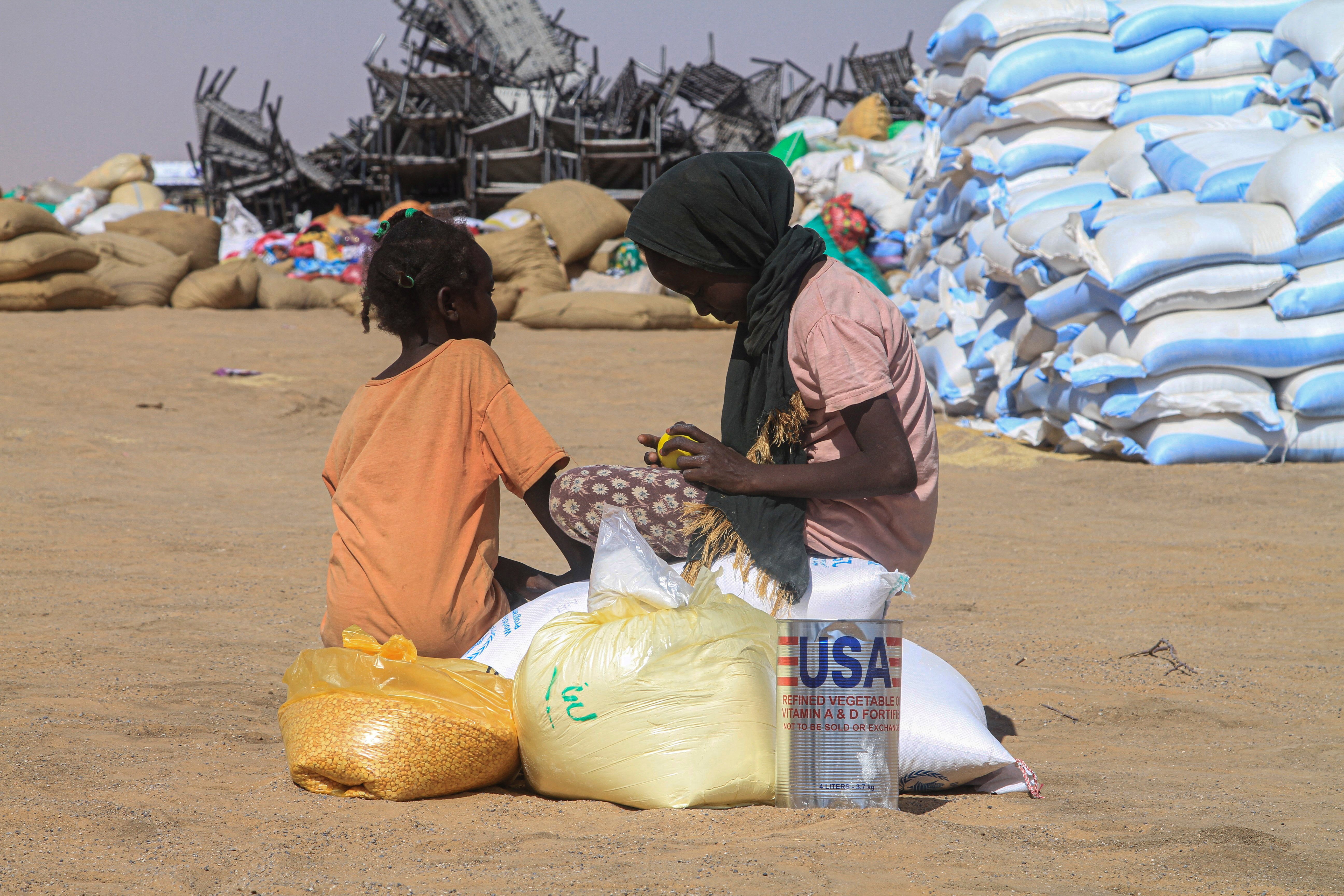 Sudanese girls who fled el-Fasher receive humanitarian aid at the al-Afad camp for displaced people in the town of al-Dabba, northern Sudan in November 2025