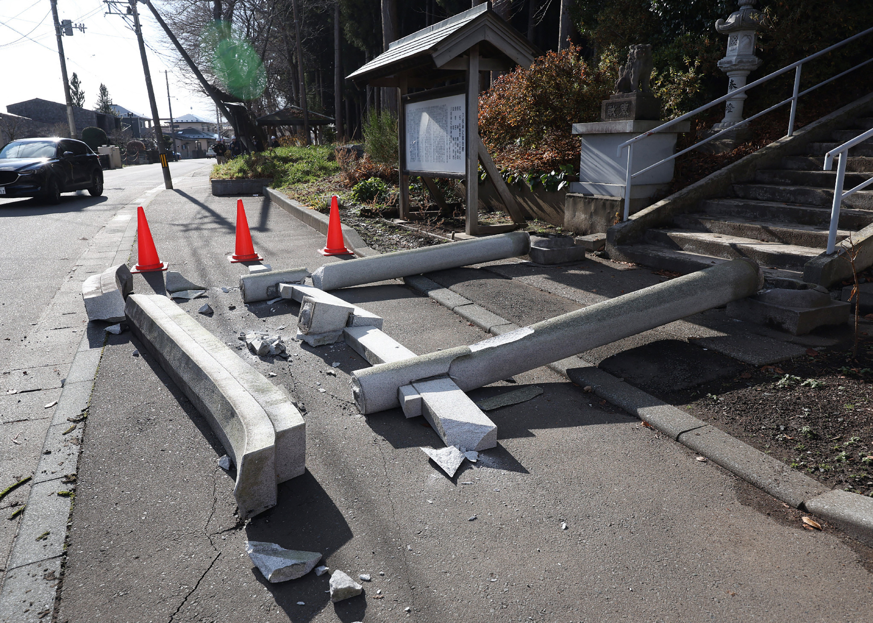 A torii gate at the entrance of Yasaka Shrine is seen after it collapsed onto a sidewalk in Hachinohe City in Aomori Prefecture on December 9, 2025, following a 7.5 magnitude earthquake off northern Japan. A big quake off northern Japan left at least 30 injured, authorities said on December 9, damaging roads and leaving thousands without power in freezing temperatures. (Photo by JIJI Press / AFP) / Japan OUT / JAPAN OUT / JAPAN OUT