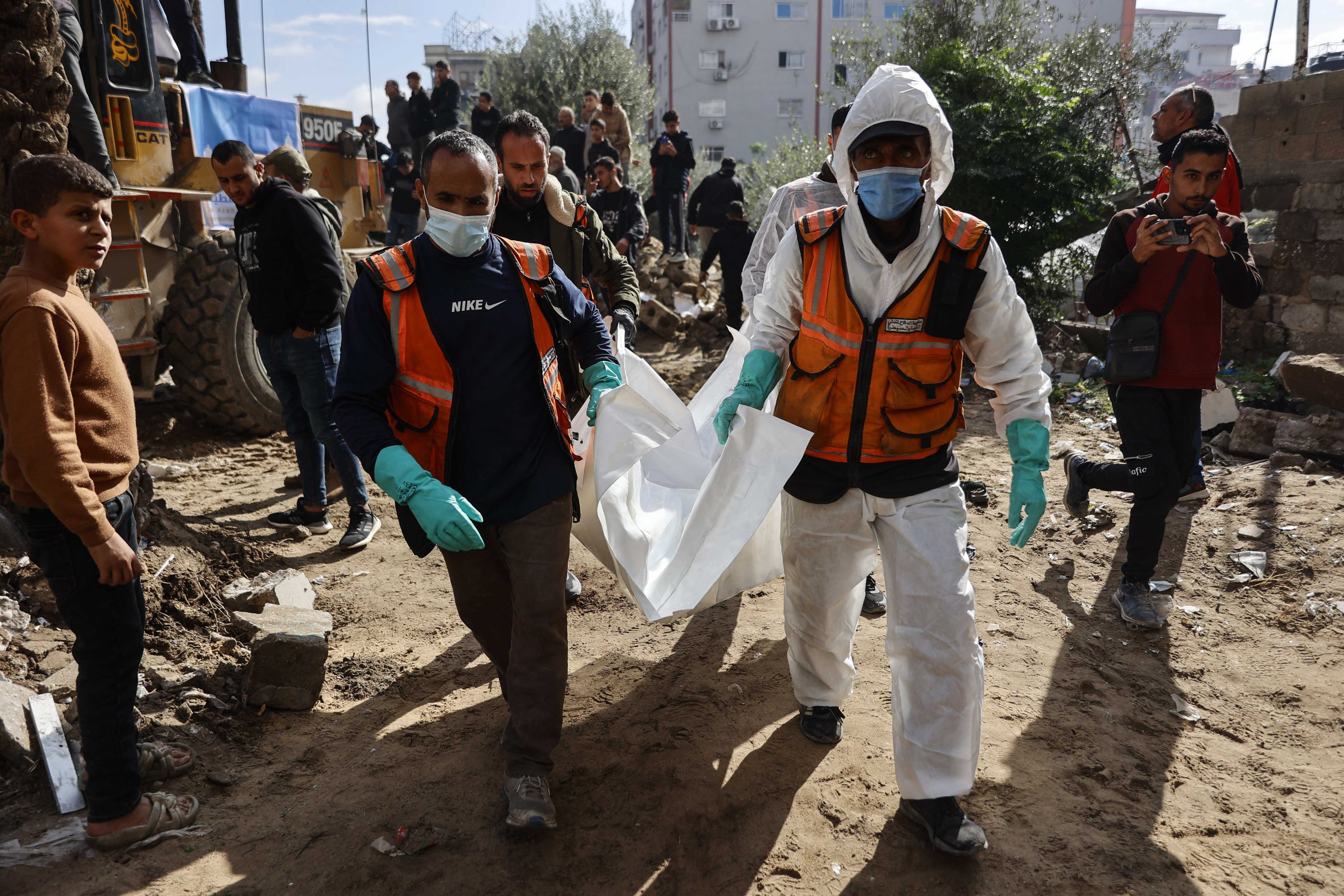 Members of the Palestinian Civil Defence search for the bodies of the Salem family in the rubble of their building, destroyed in 2023 in the Remal neighbourhood of Gaza City, December 15, 2025 [AFP]