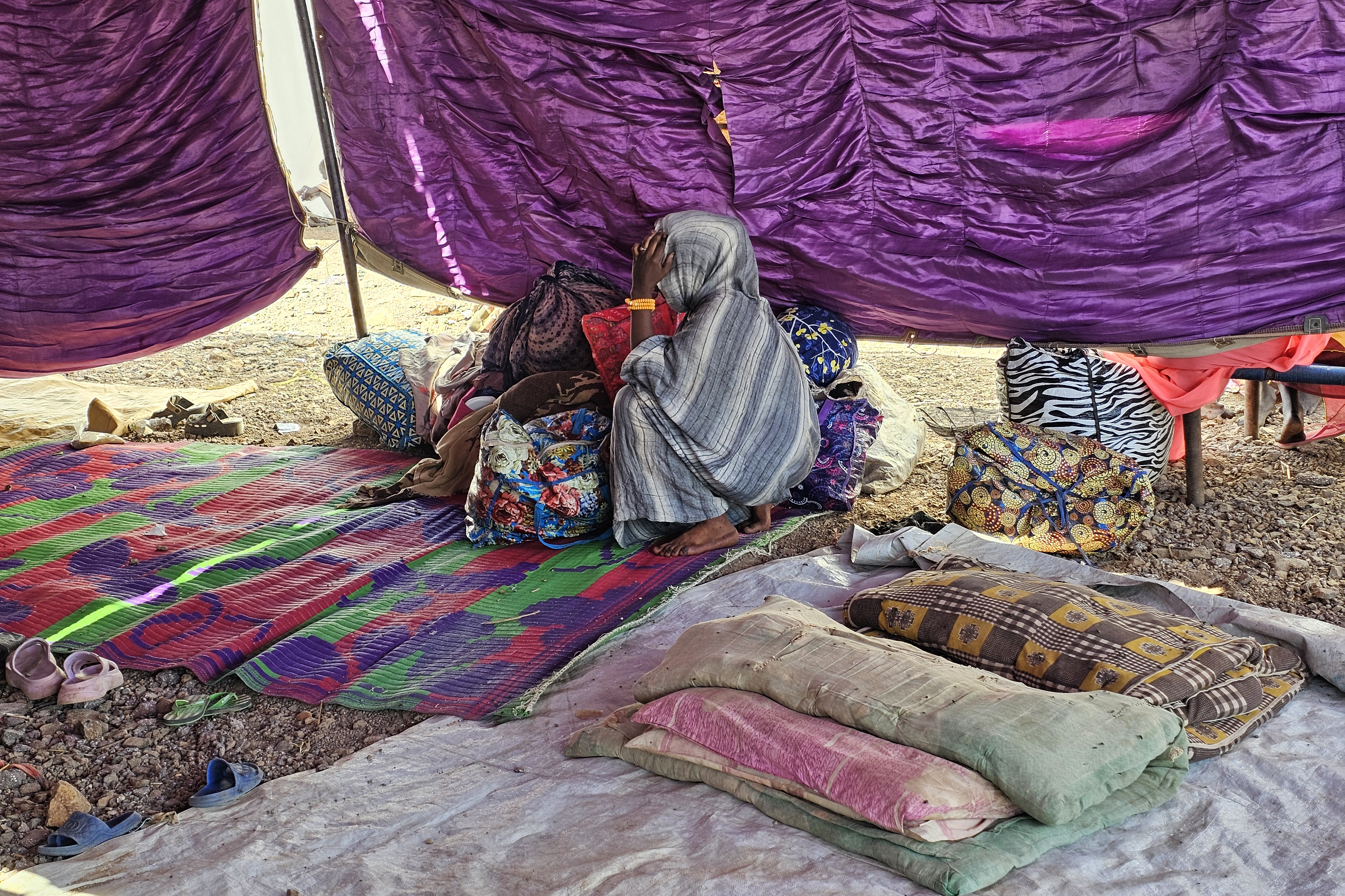 A young displaced Sudanese girl reacts after spending a night with others in Gedaref city eastern Sudan on December 26, 2025 after the Rapid Support Forces (RSF) took control of the Heglig area in western Sudan. Since its outbreak in April 2023, the war between Sudan's army and the paramilitary Rapid Support Forces (RSF) has killed tens of thousands of people and displaced nearly 12 million. At the end of October, the paramilitary group seized control El-Fasher, the conclusion of a bitter 18-month siege for the strategic hub in western Sudan's Darfur region and marked by reports of mass killings and sexual violence. (Photo by AFP)