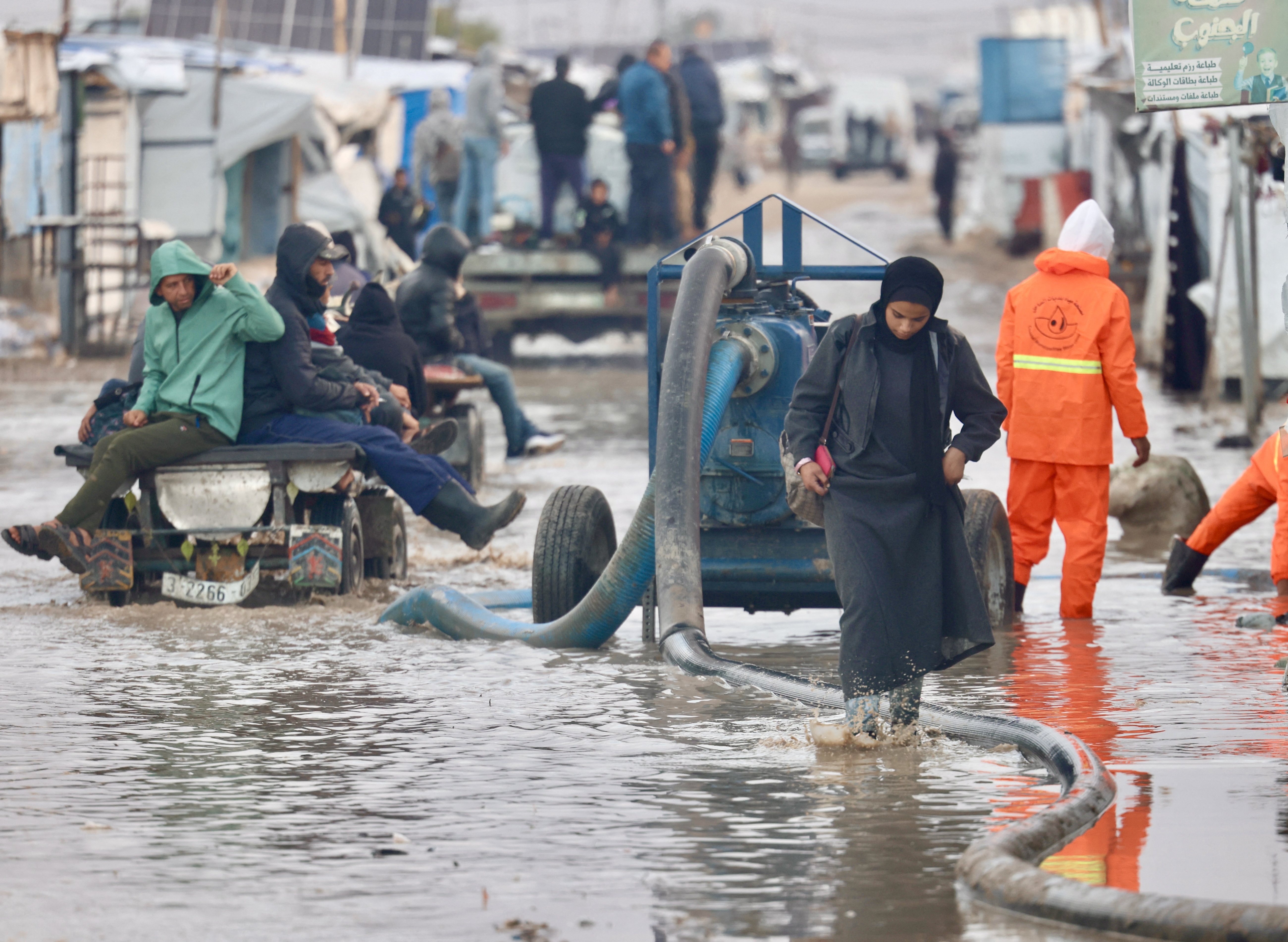 Workers drain floodwaters in Gaza's al-Mawasi camp