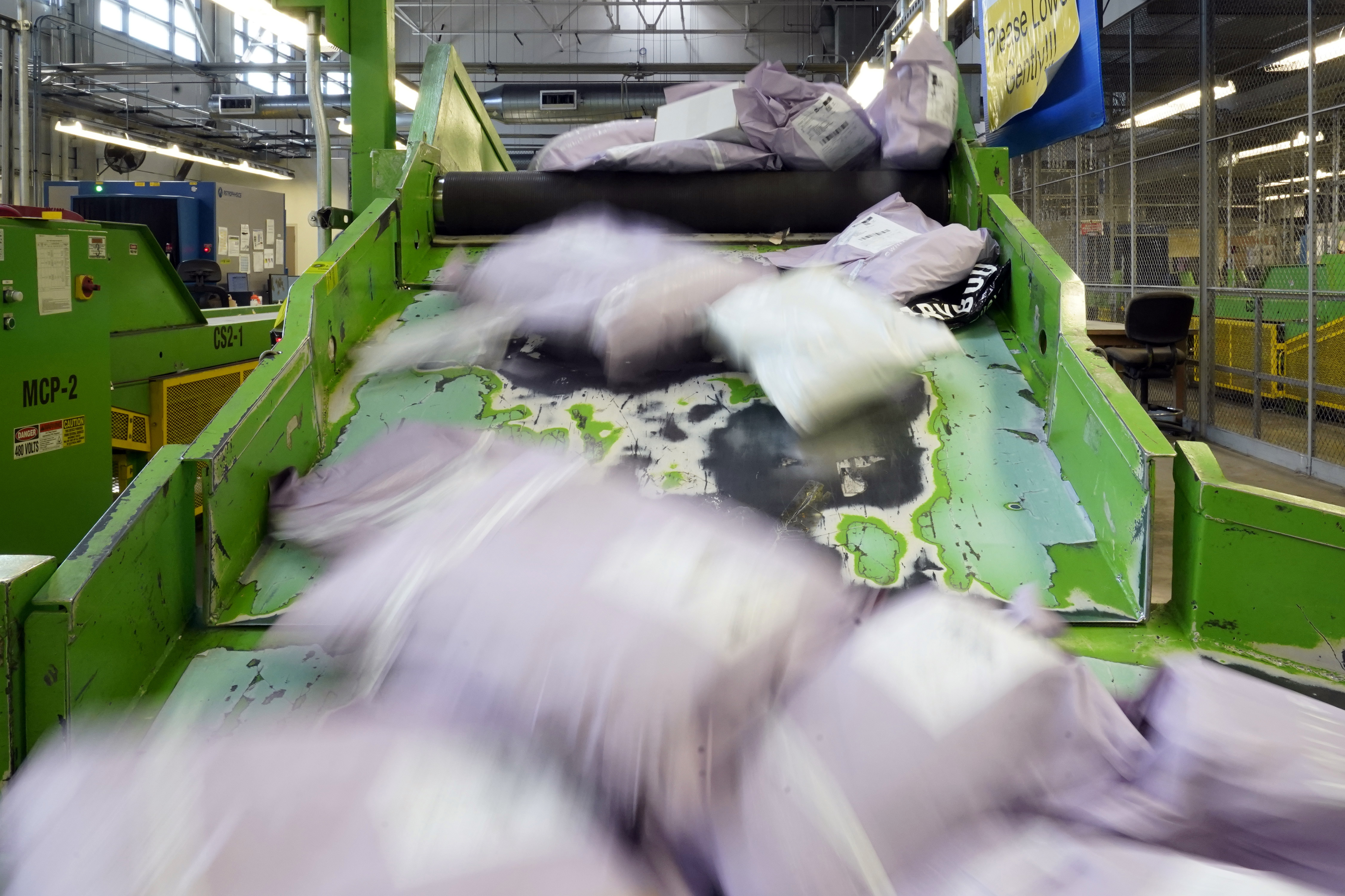 Parcels slide down a ramp after being scanned at the U.S. Customs and Border Protection overseas mail inspection facility at Chicago's O'Hare International Airport in USA