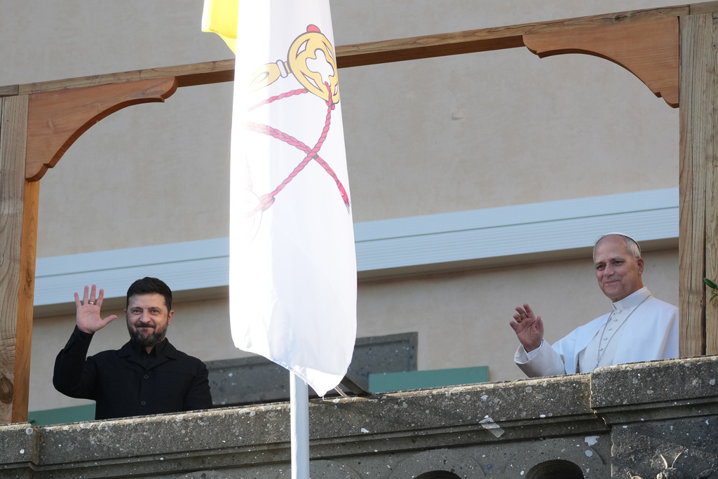 Ukraine's President Volodymyr Zelenskyy and Pope Leo XIV wave to journalists during their meeting in Castel Gandolfo, Italy, on December 9, 2025 [Andrew Medichini/AP Photo]