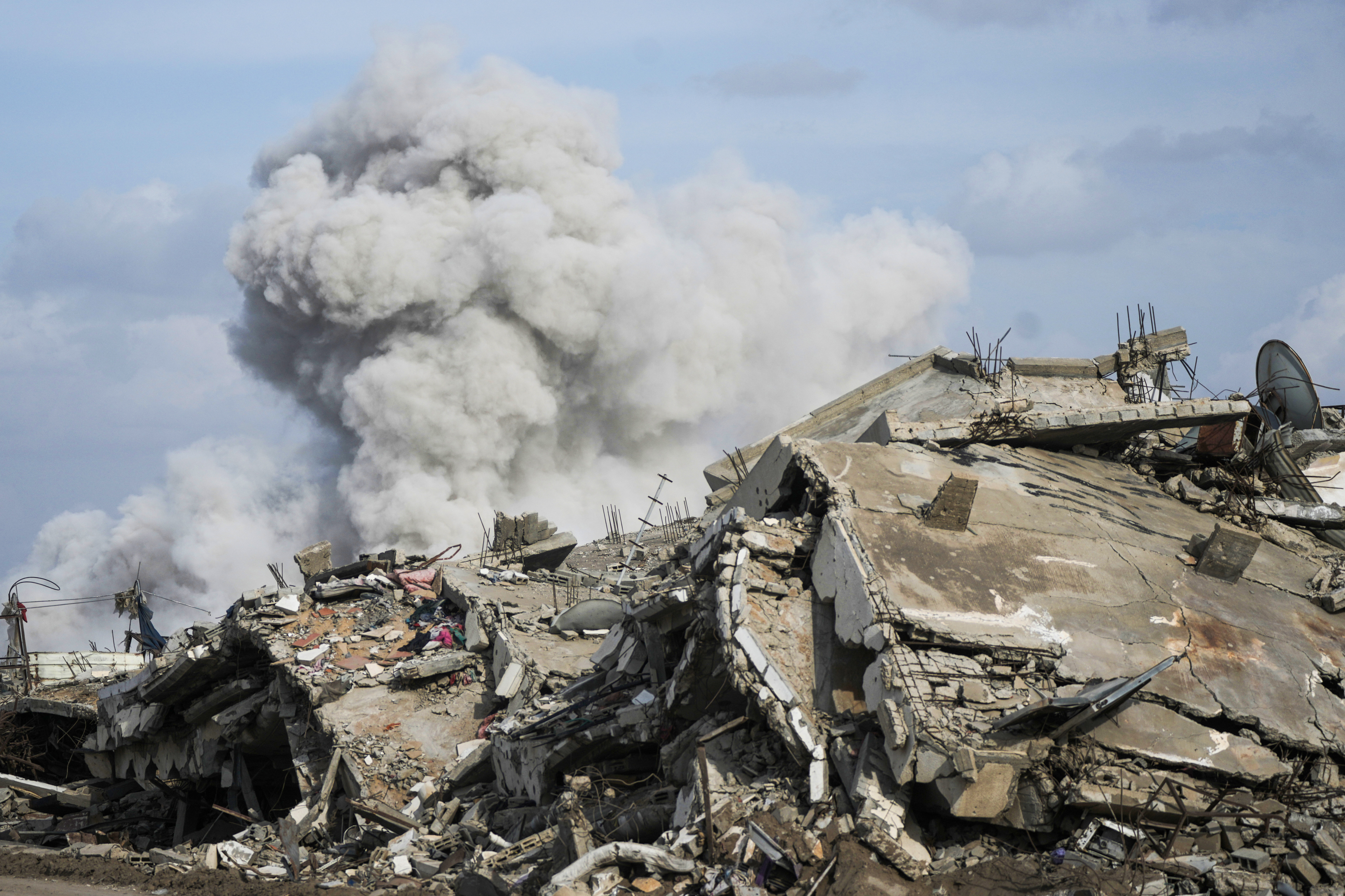 Smoke rises as Israeli military demolish a house east of Gaza City, Tuesday, Dec. 9, 2025. (AP Photo/Jehad Alshrafi)