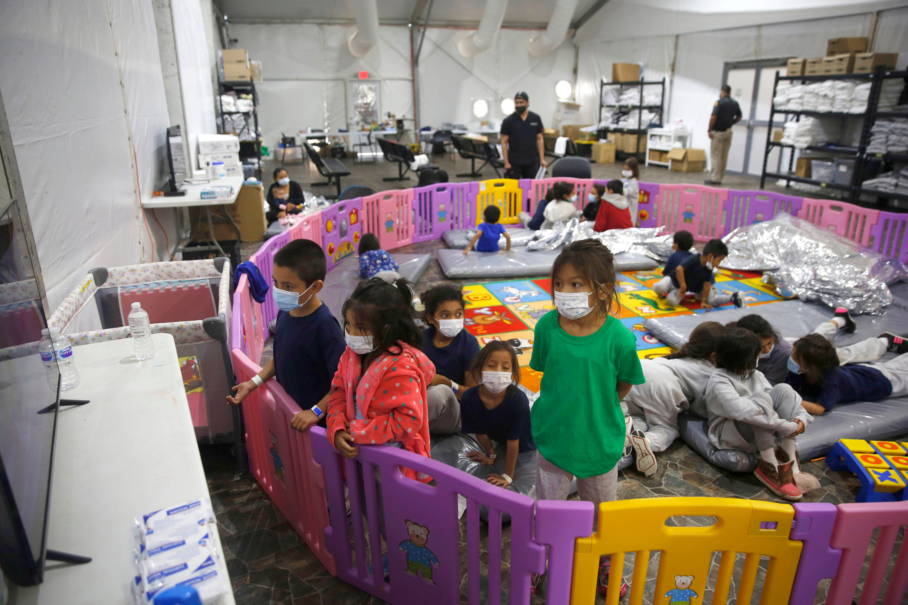 Migrant children sit in a play area in Donna, Texas
