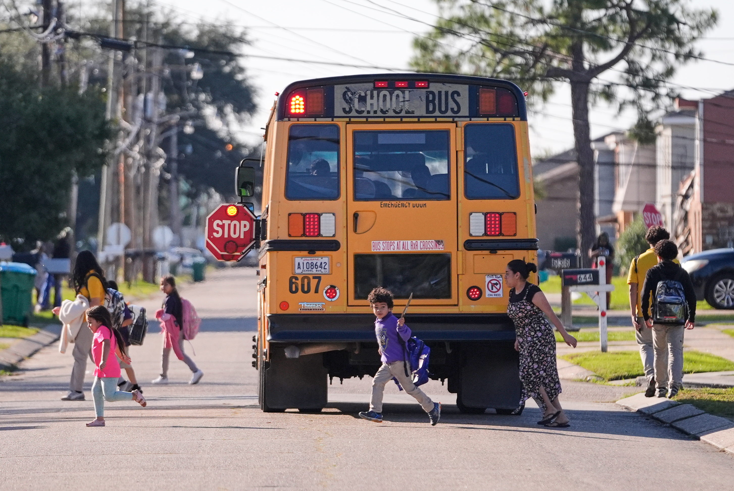 Kids disembark from a school bus in Louisiana