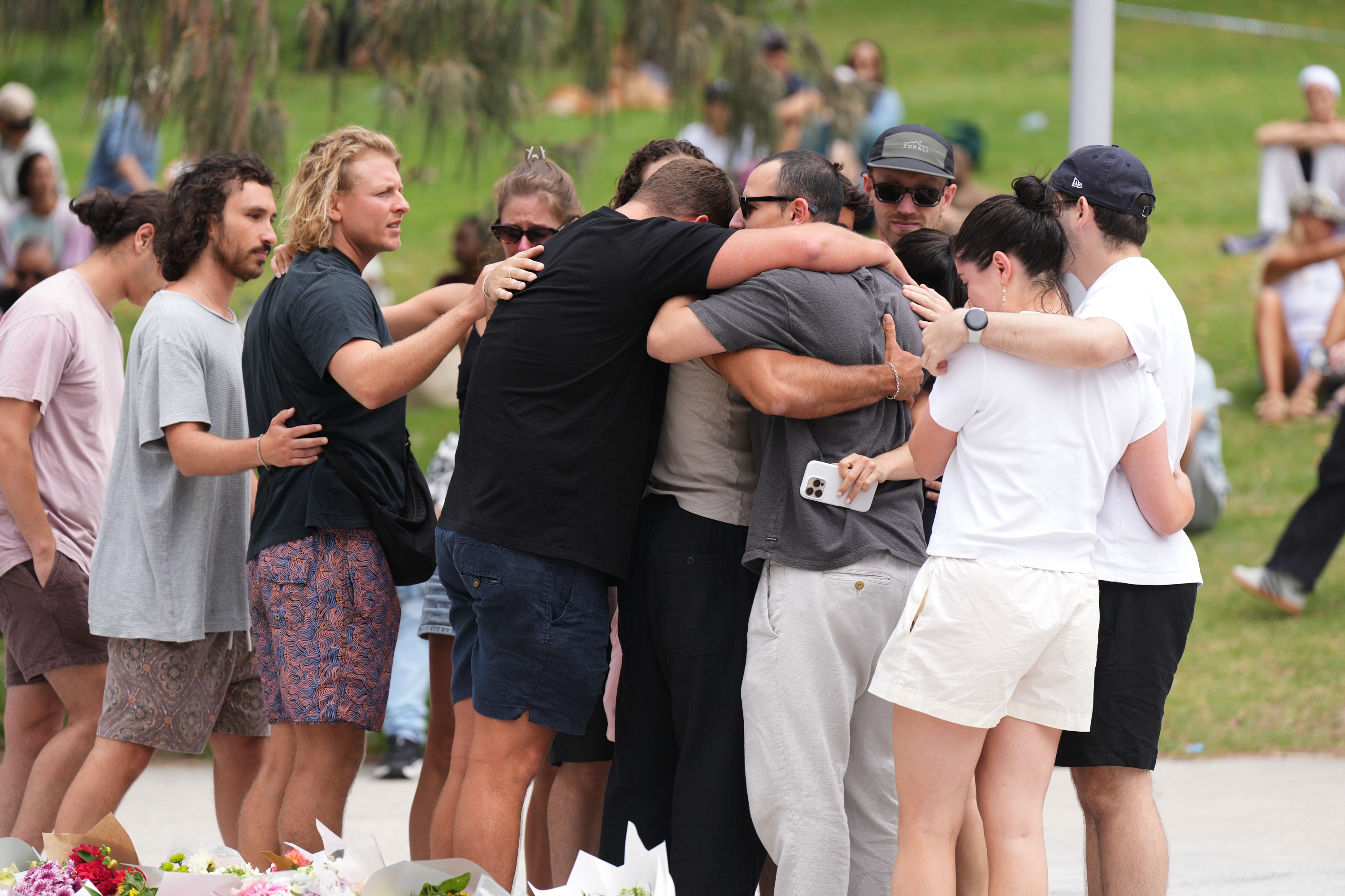 Mourners hug at Bondi Beach