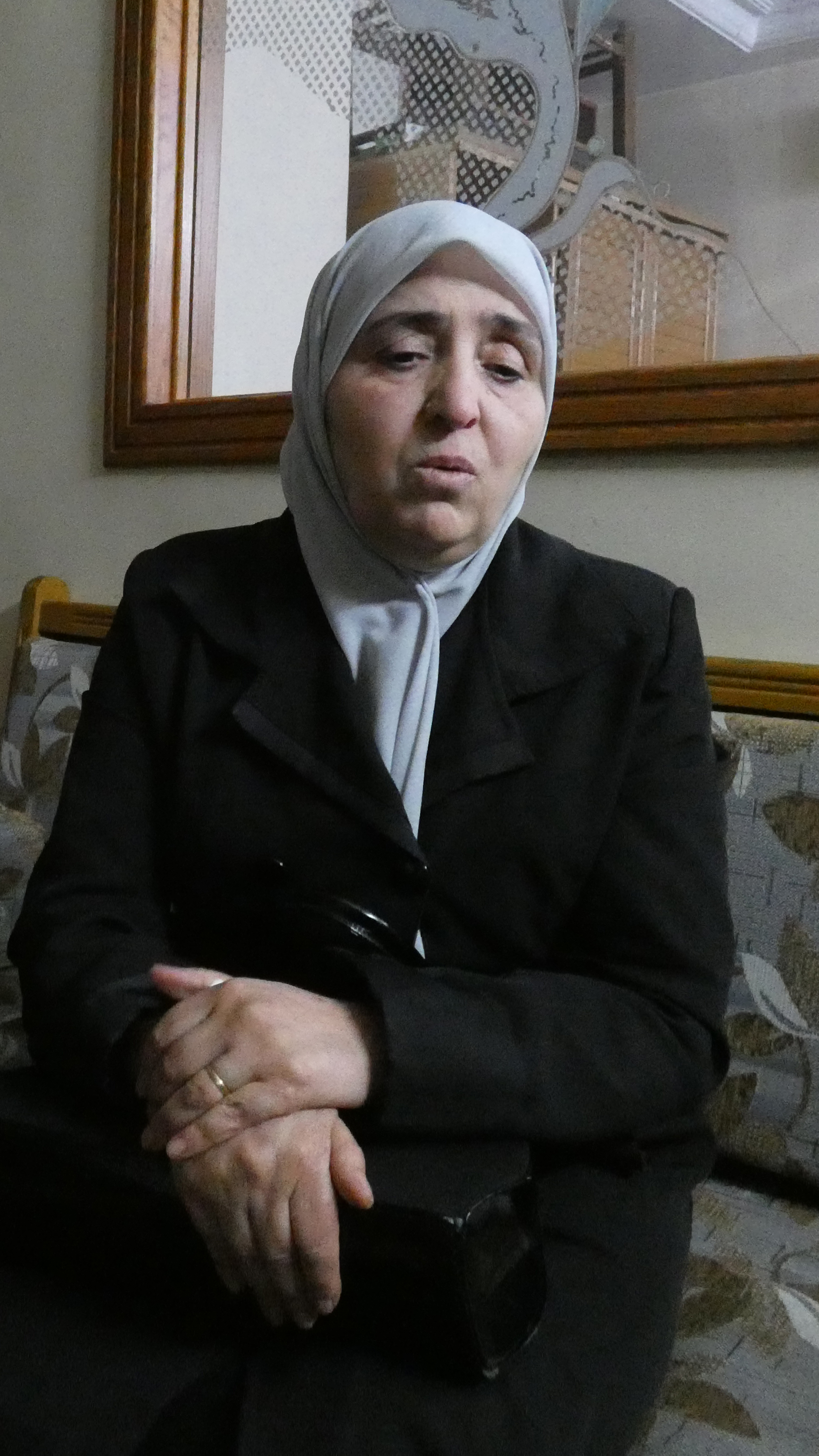 Ghada, 55, left, and Najwa, 60, are still mourning the disappearance of their brother Ayman [Caolán Magee/ Al Jazeera]