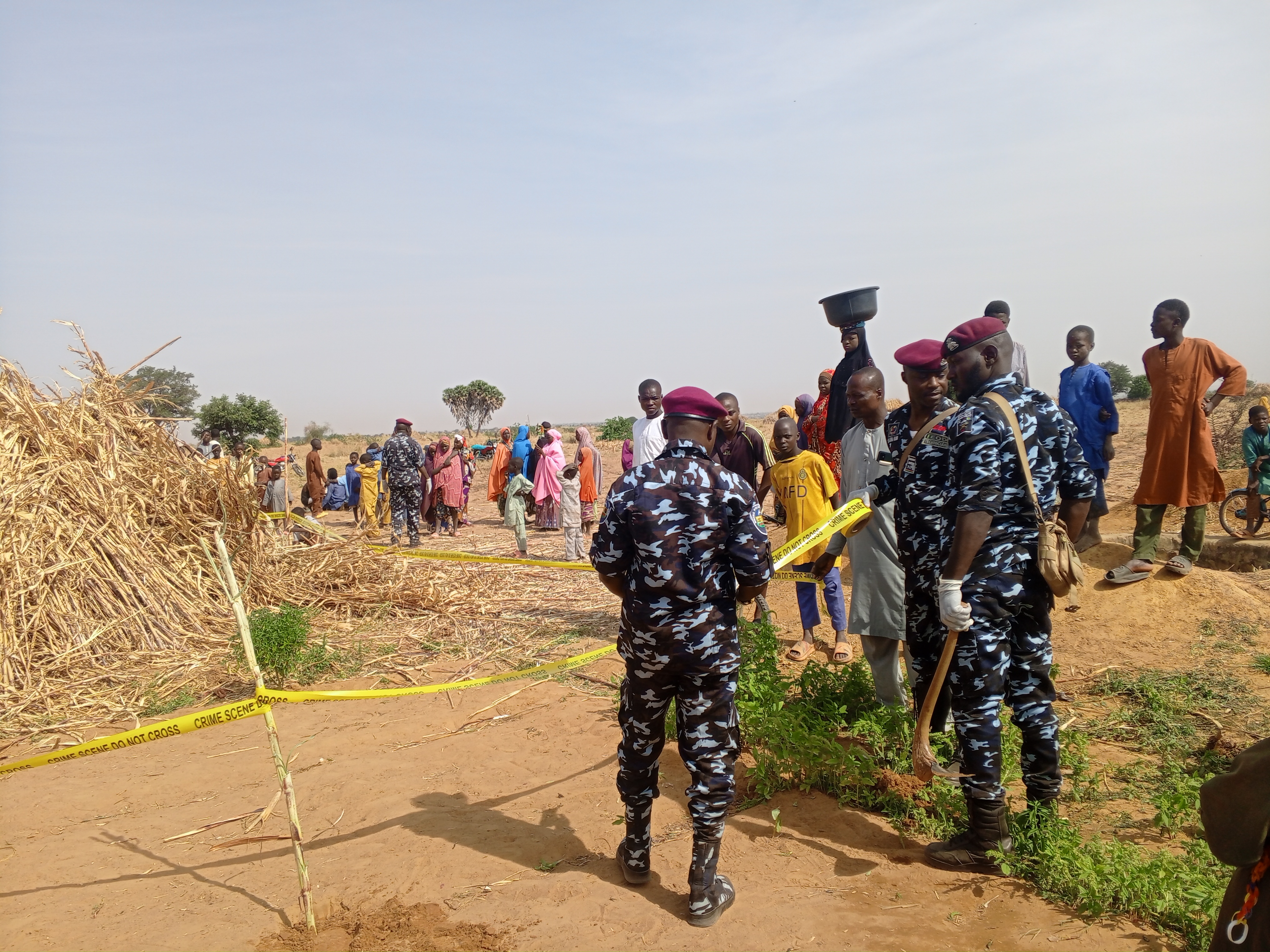Police stand with yellow tape