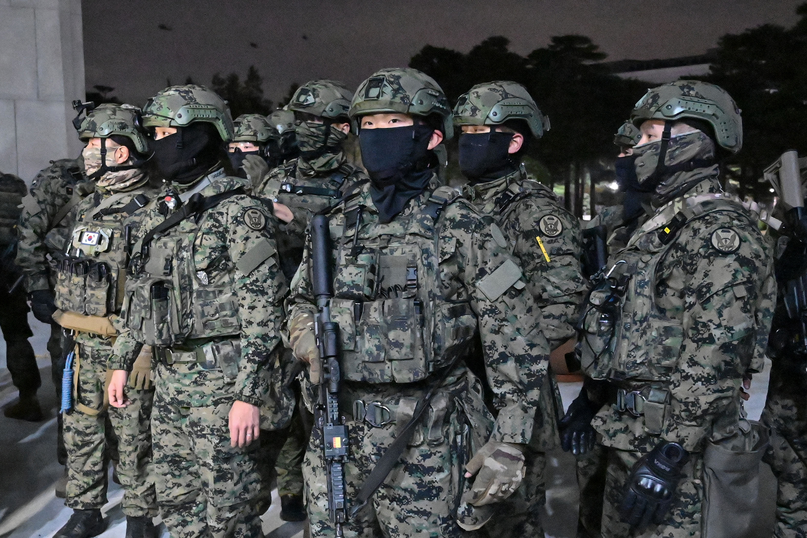 (FILES) In this file photo taken early on December 4, 2024, soldiers try to enter the National Assembly building in Seoul, after then South Korea president Yoon Suk Yeol declared martial law.