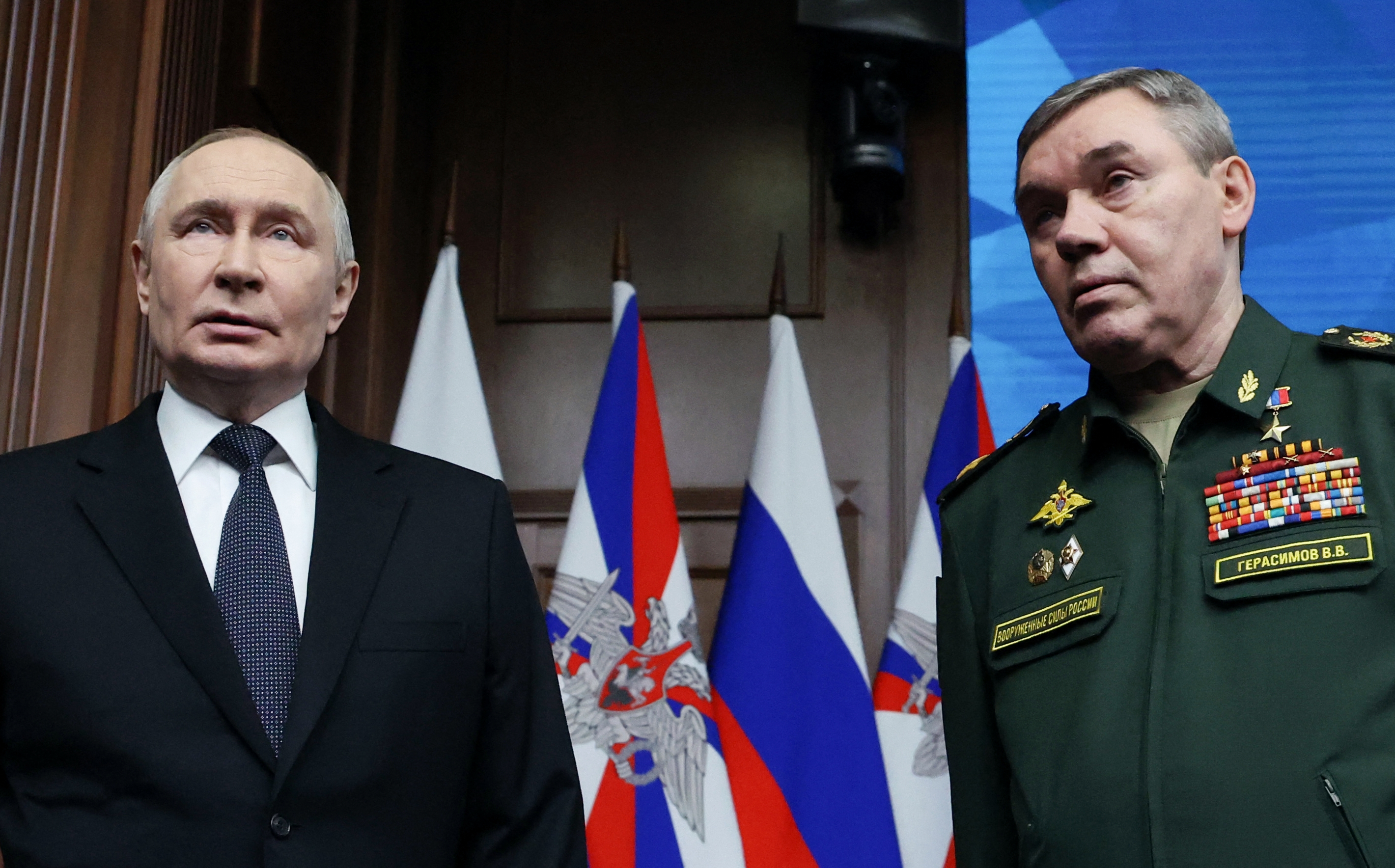 In this pool photograph distributed by the Russian state agency Sputnik, Russia's President Vladimir Putin and Chief of the General Staff Valery Gerasimov attend an expanded meeting of the Russian Defence Ministry Board at the National Defence Control Centre in Moscow on December 17, 2025.