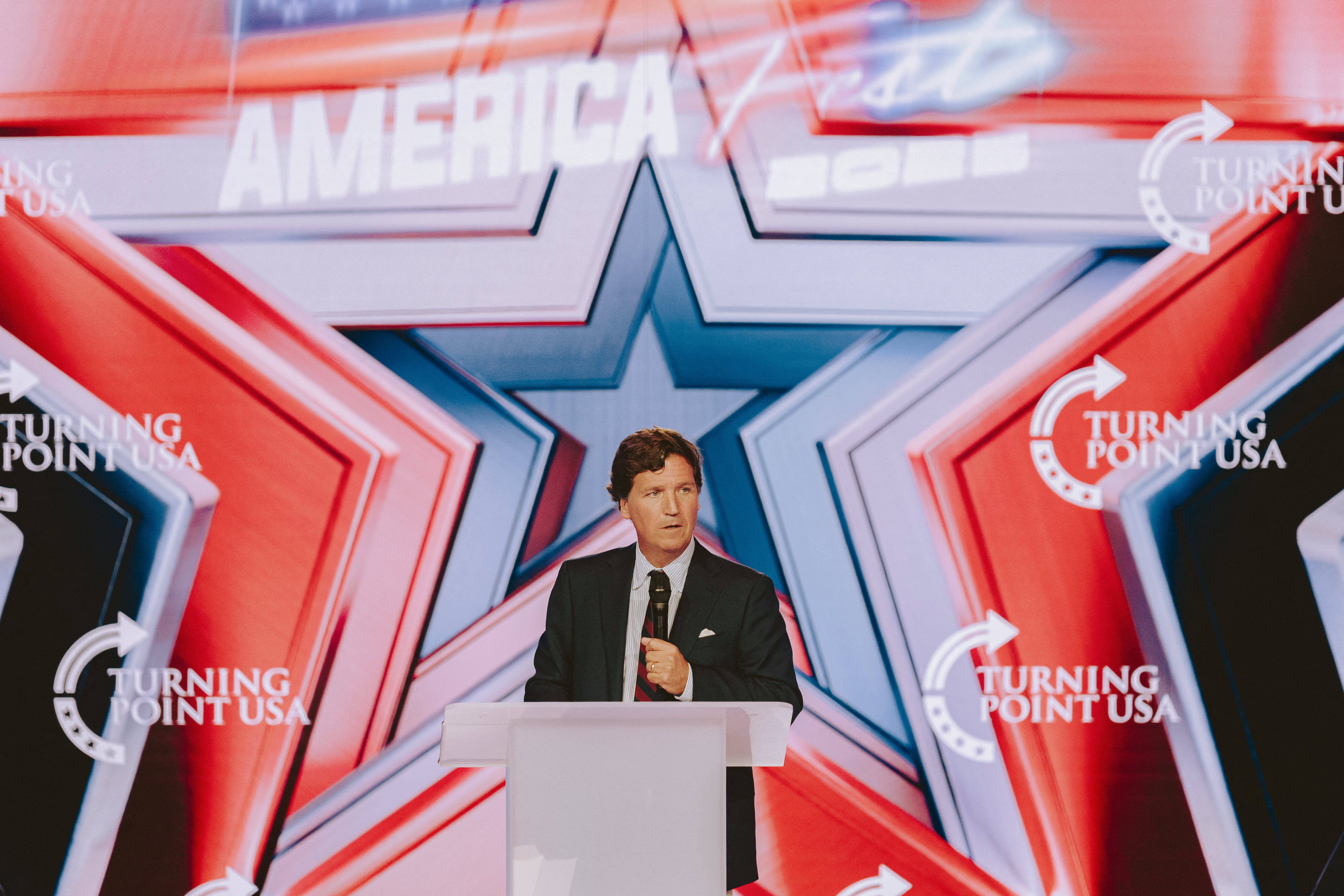 Conservative political commentator and podcast host Tucker Carlson speaks at Turning Point's annual AmericaFest conference, in remembrance of late right-wing political activist Charlie Kirk, in Phoenix, Arizona on December 18, 2025.