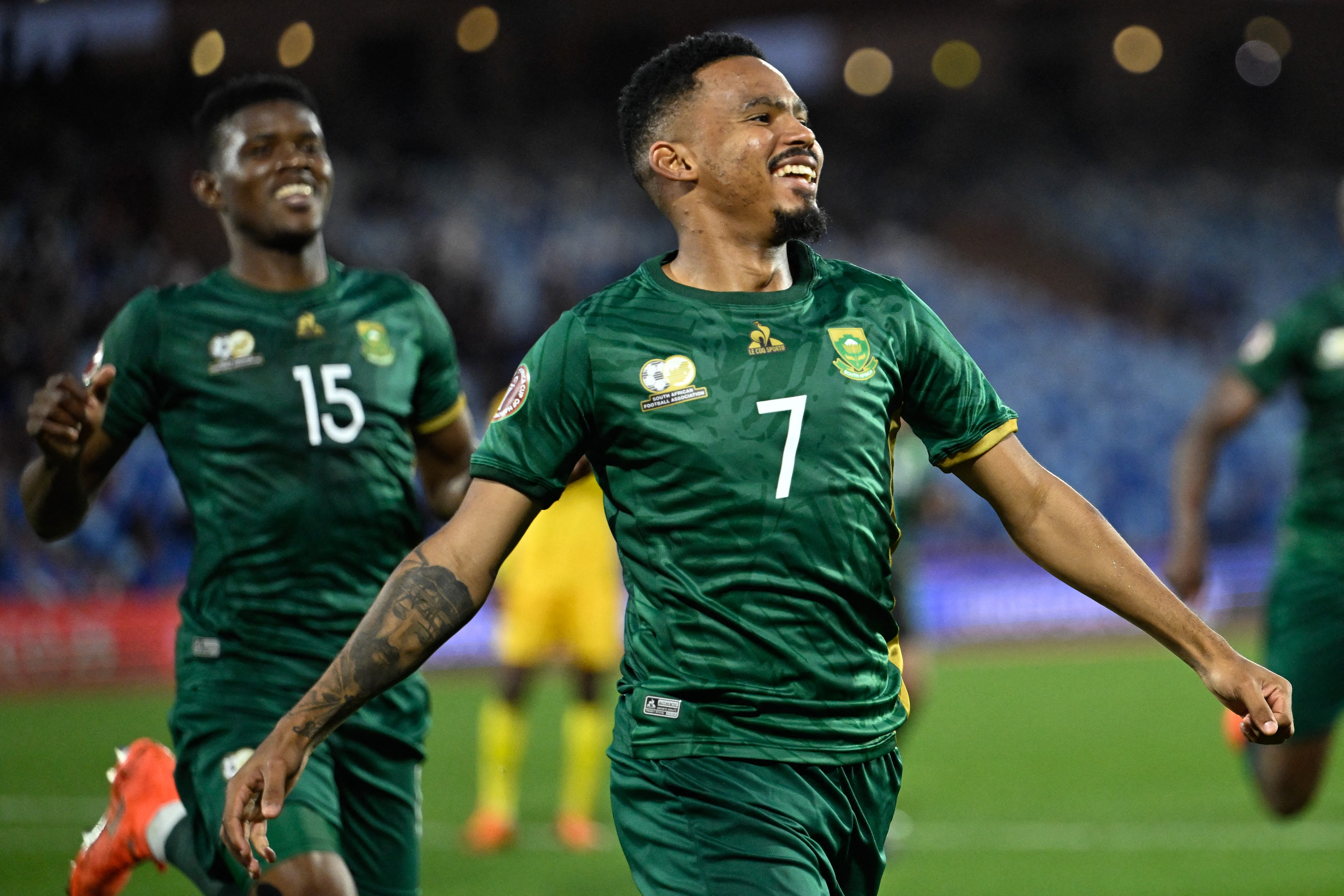 South Africa's midfielder #07 Oswin Appollis celebrates scoring the team's third goal from a penalty during the Africa Cup of Nations (CAN) Group B football match between Zimbabwe and South Africa at Marrakesh Stadium in Marrakesh on December 29, 2025.