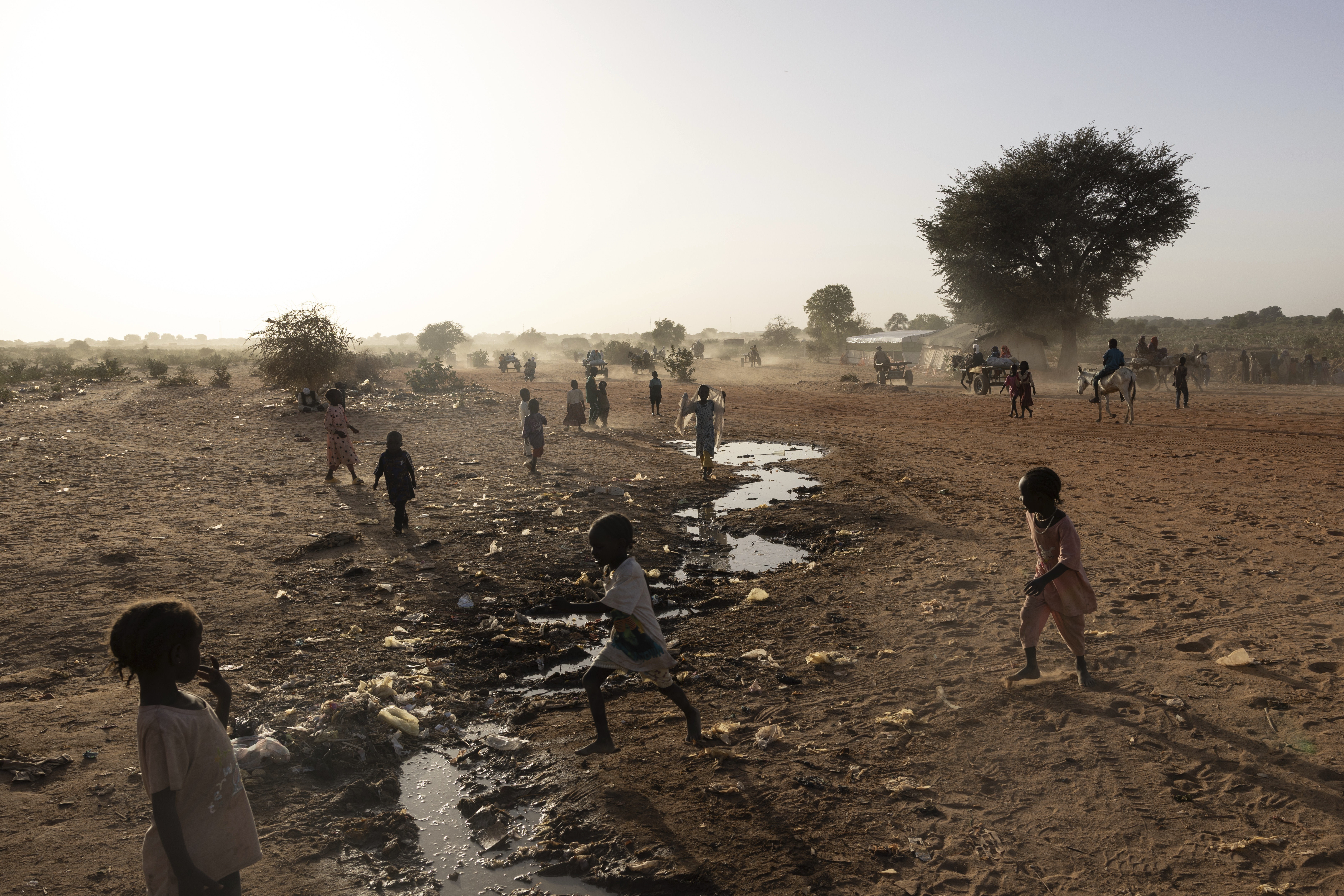 Sudanese children play by the Sudanese border in the Adre, Chad, transit camp, Wednesday , May 7, 2025. (AP Photo/Caitlin Kelly)