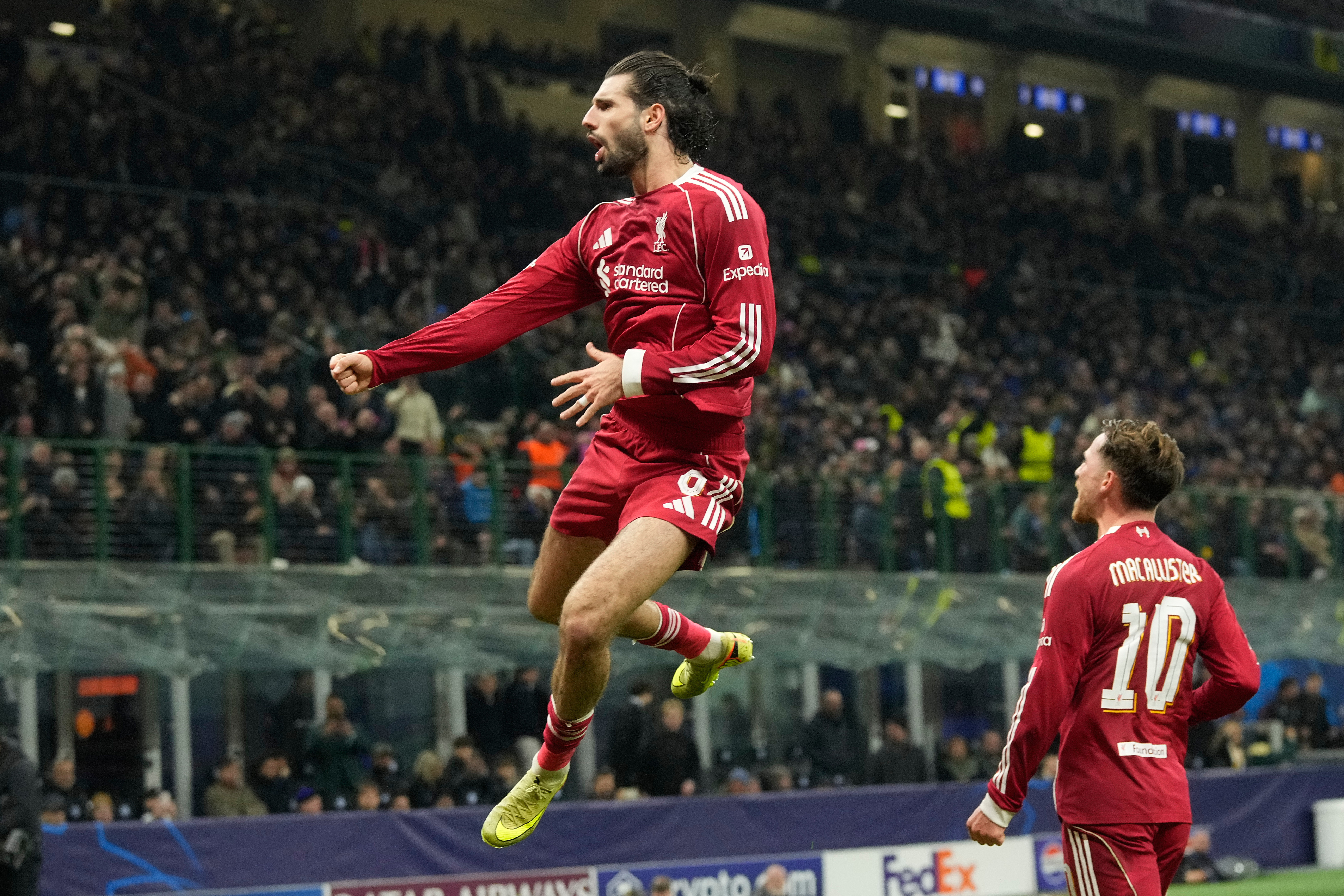 Liverpool's Dominik Szoboszlai celebrates after scoring his side's first goal from a penalty shot during a Champions League, league phase, soccer match between Inter Milan and Liverpool in Milan, Italy, Tuesday, Dec.9, 2025. (AP Photo/Luca Bruno)