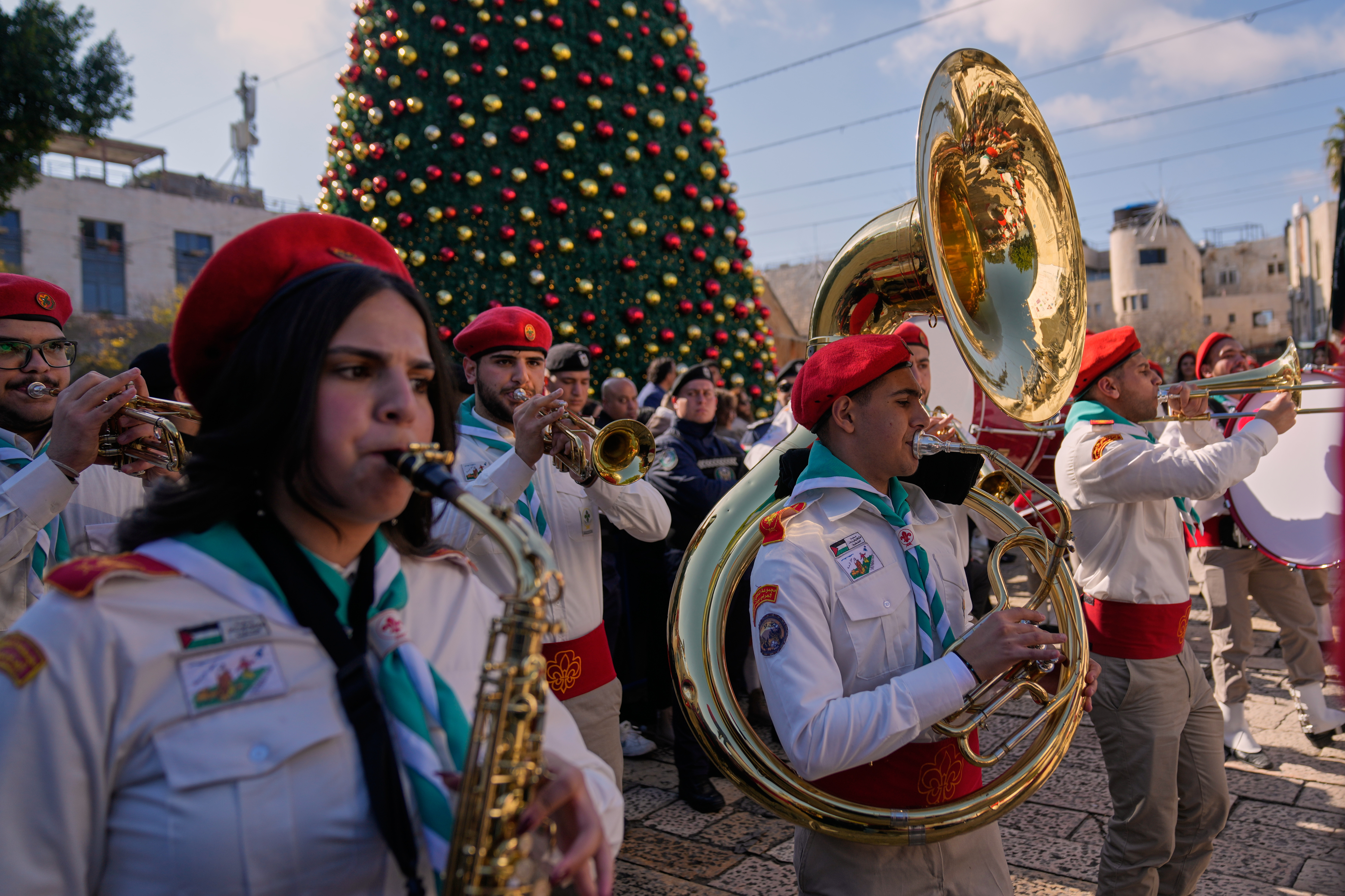Palestinian scout bands parade at the Manger Square near the Church of the Nativity, traditionally believed to be the birthplace of Jesus, on Christmas Eve, in the West Bank city of Bethlehem, Wednesday, Dec. 24, 2025. (AP Photo/Nasser Nasser)