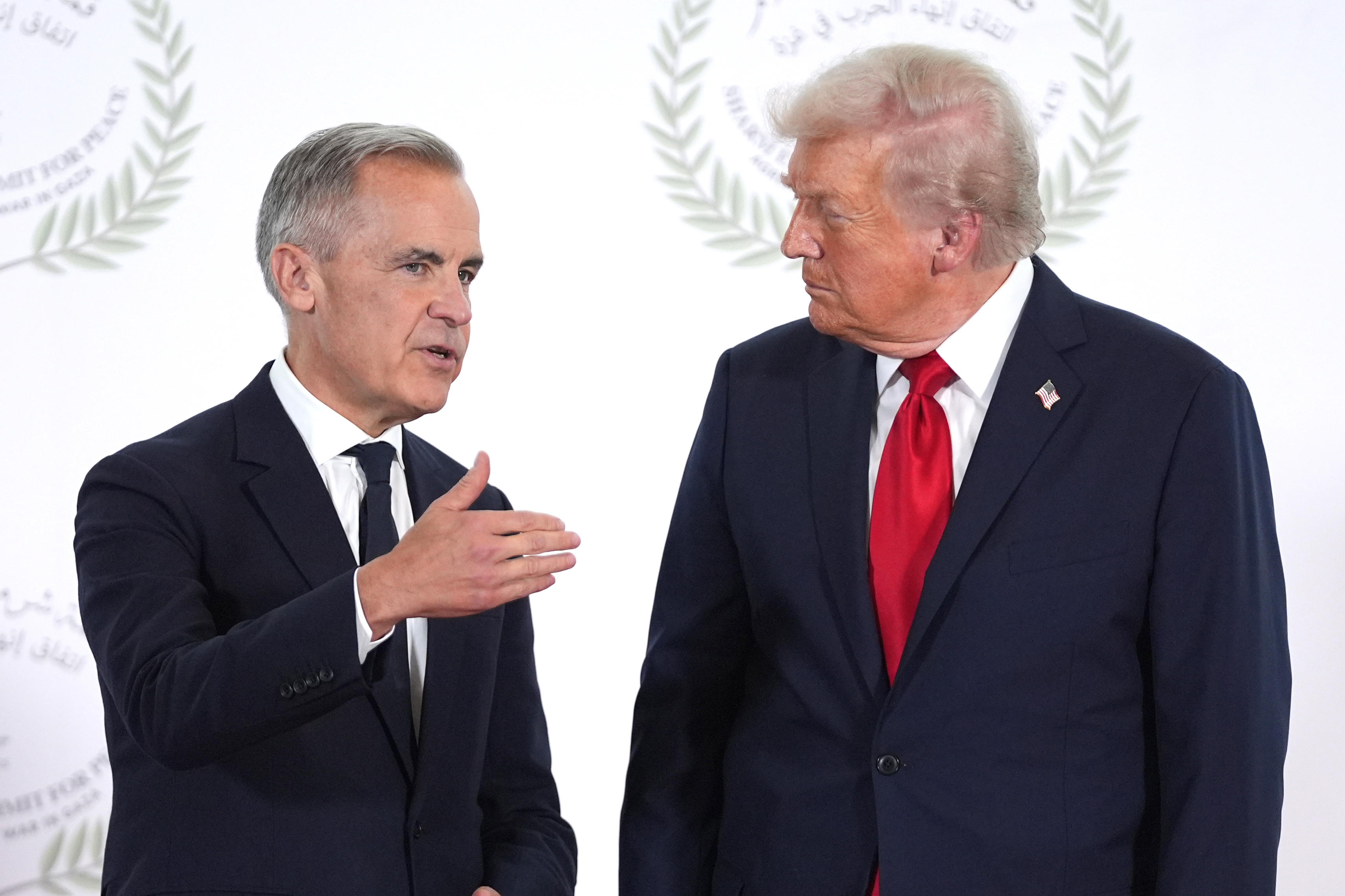 SHARM EL-SHEIKH, EGYPT - OCTOBER 13: President Donald Trump greets Canada's Prime Minister Mark Carney during a world leaders' summit on ending the Gaza war on October 13, 2025 in Sharm El-Sheikh, Egypt. President Trump is in Egypt to meet with European and Middle Eastern leaders in what’s being billed as an international peace summit, following the start of a US-brokered ceasefire deal to end the war in the Gaza Strip. (Photo by Evan Vucci - Pool / Getty Images)