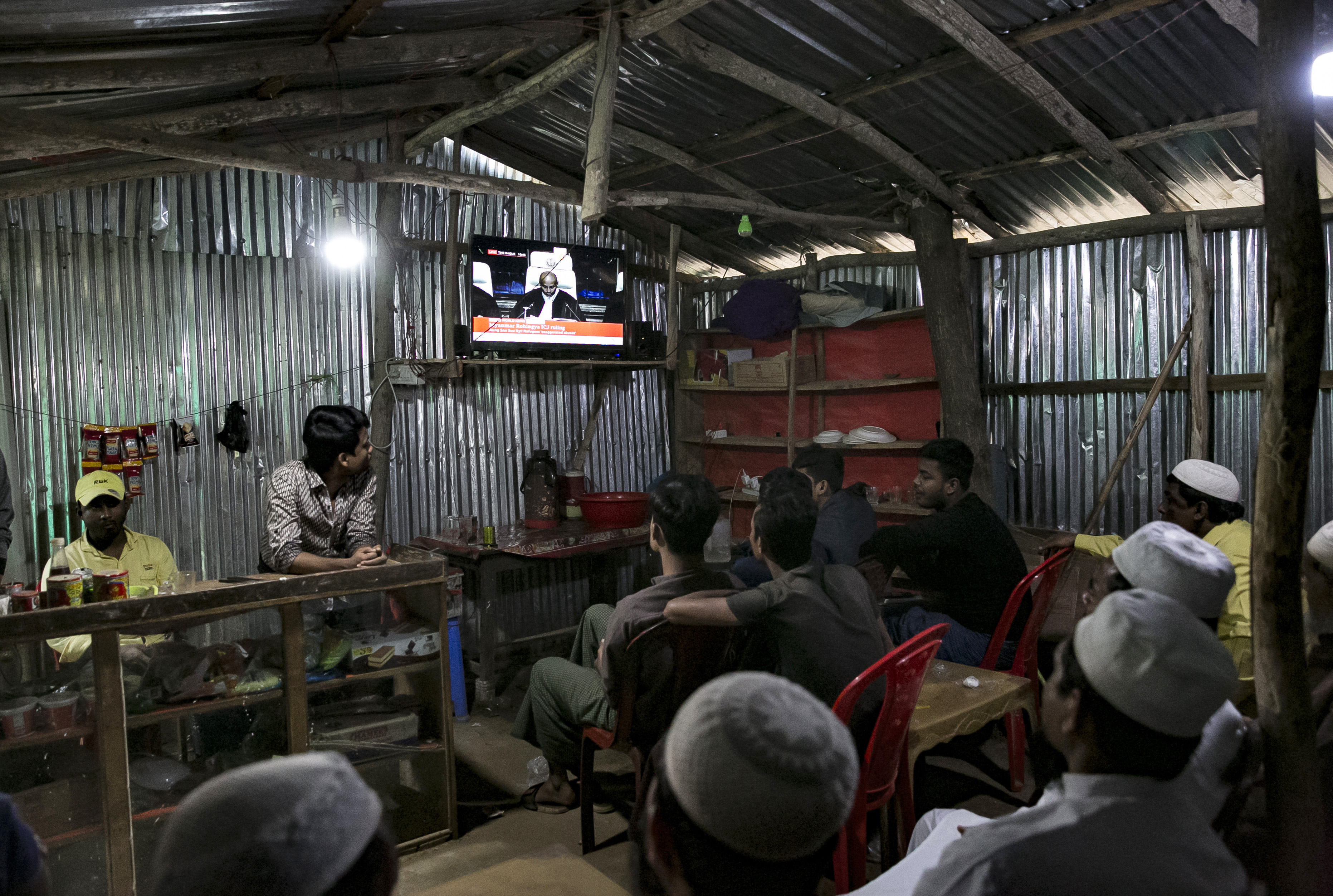 COX'S BAZAR, BANGLADESH - JANUARY 23: People watch the ICJ hearing at a restaurant in a Rohingya refugee camp on January 23, 2020 in Cox's Bazar, Bangladesh. On Thursday, the International Court of Justice ordered Myanmar to take emergency measures to prevent genocide of the Rohingya. In a unanimously-ruled order the court upheld the provisions of the 1948 Genocide Convention - saying Myanmar had "caused irreparable damage to the rights of the Rohingya". (Photo by Allison Joyce/Getty Images)