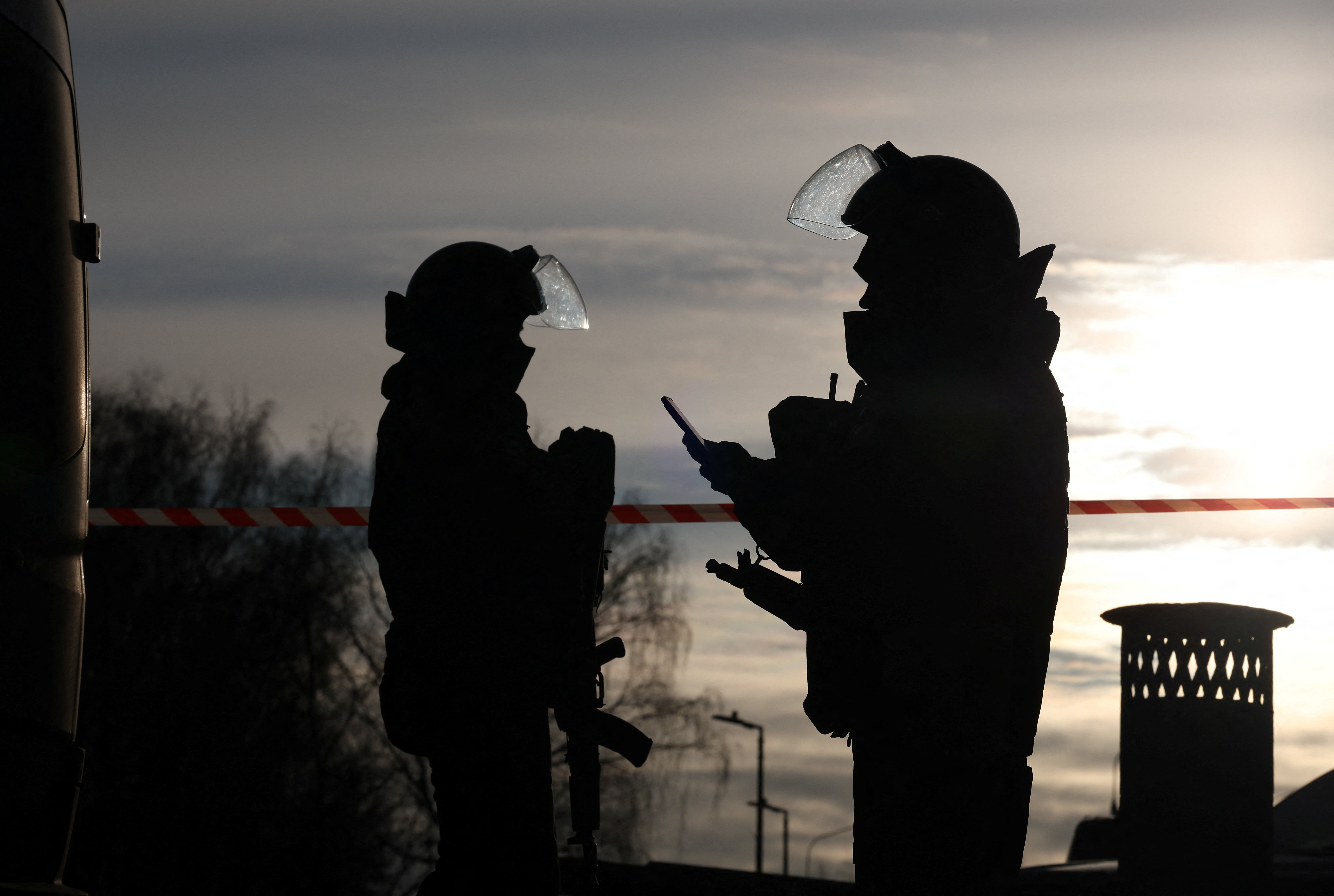 Law enforcement officers work near the scene where two traffic police officers and another person were killed in a blast in Moscow, Russia December 24, 2025. REUTERS/Ramil Sitdikov