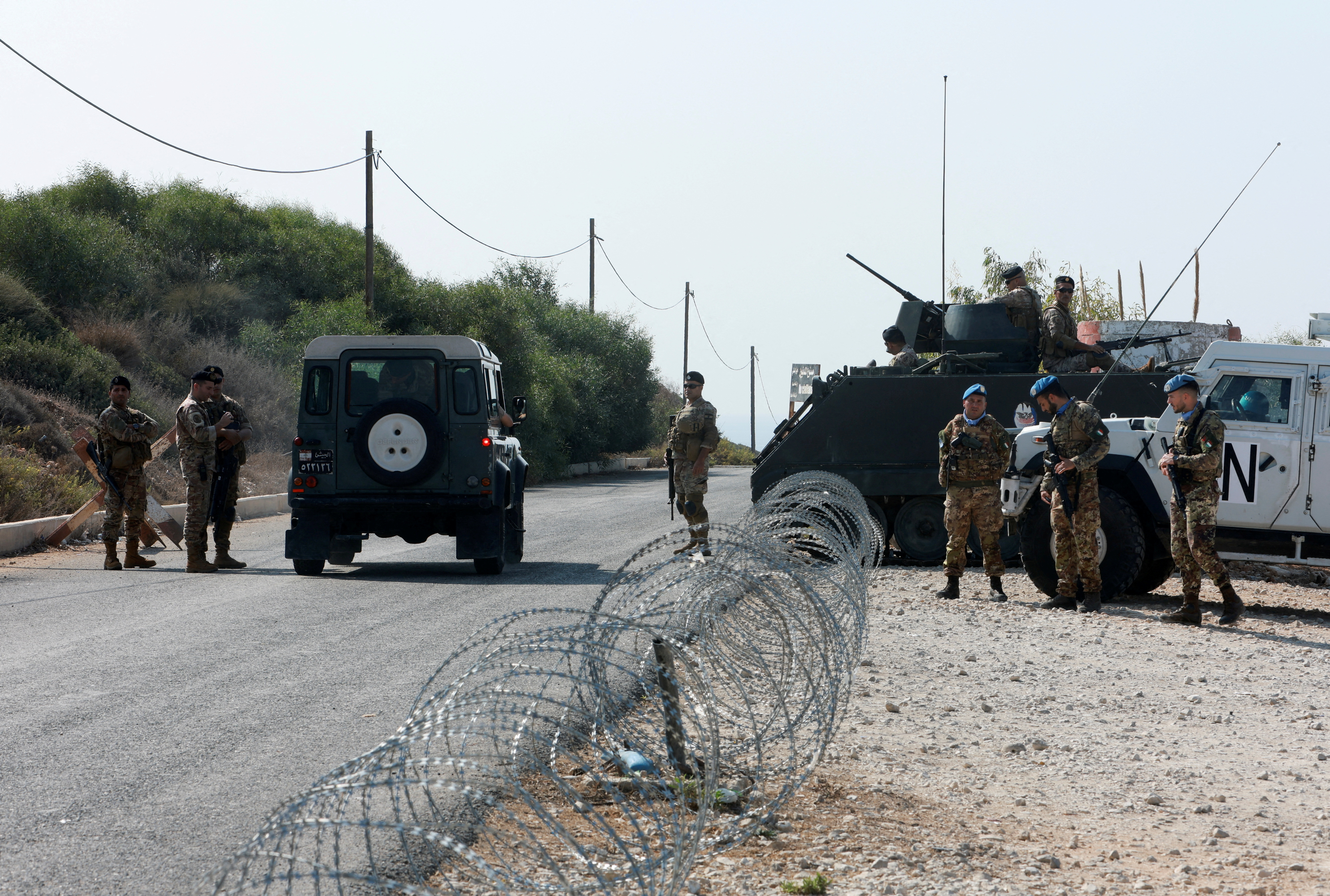 FILE PHOTO: United Nations peacekeepers (UNIFIL) and Lebanese army soldiers stand guard at a checkpoint in Naqoura, near the Lebanese-Israeli border, southern Lebanon, October 27, 2022. REUTERS/Aziz Taher/File Photo