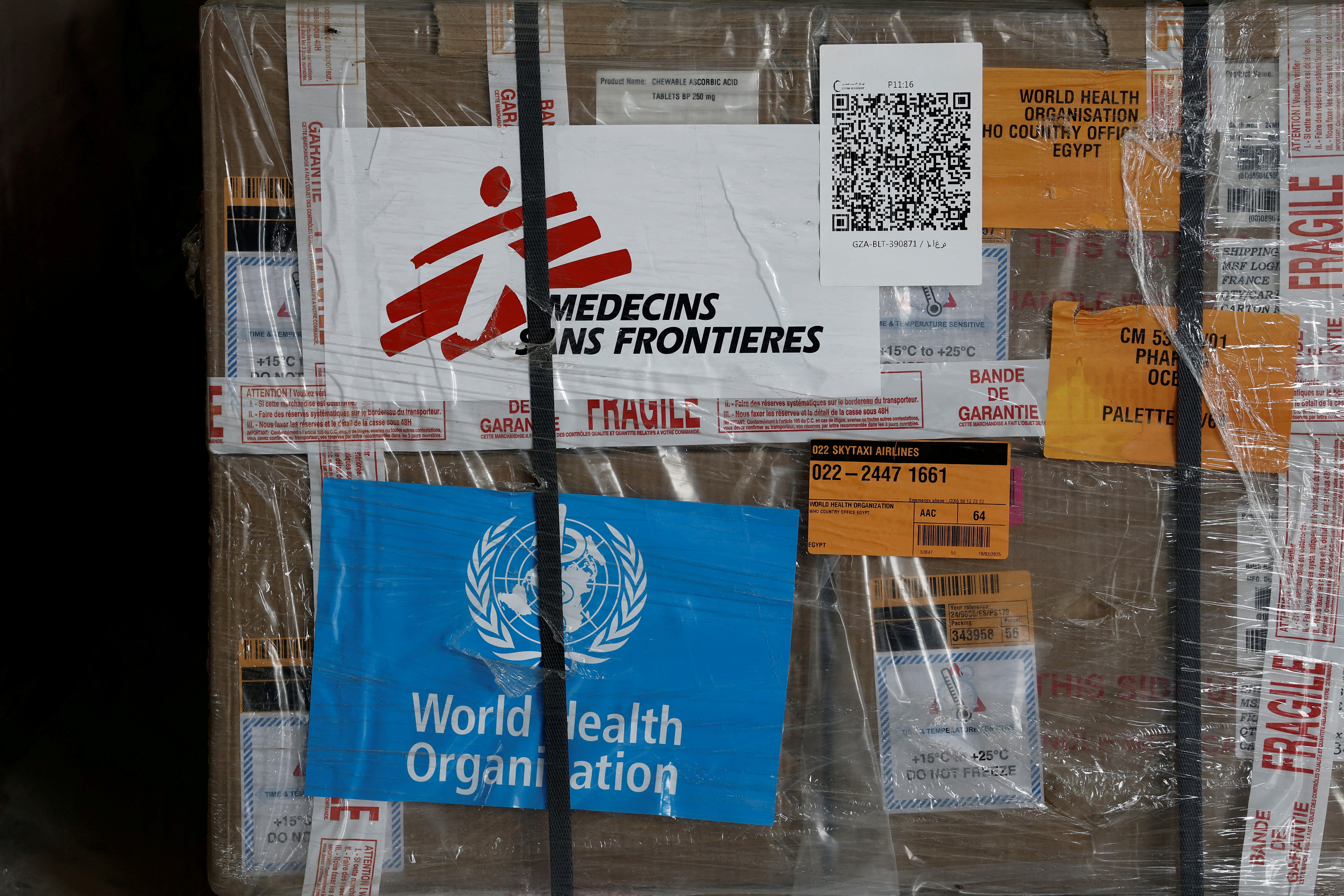 View of humanitarian supplies for Gaza, with the logos of Doctors Without Borders, or MSF, and the World Health Organization.