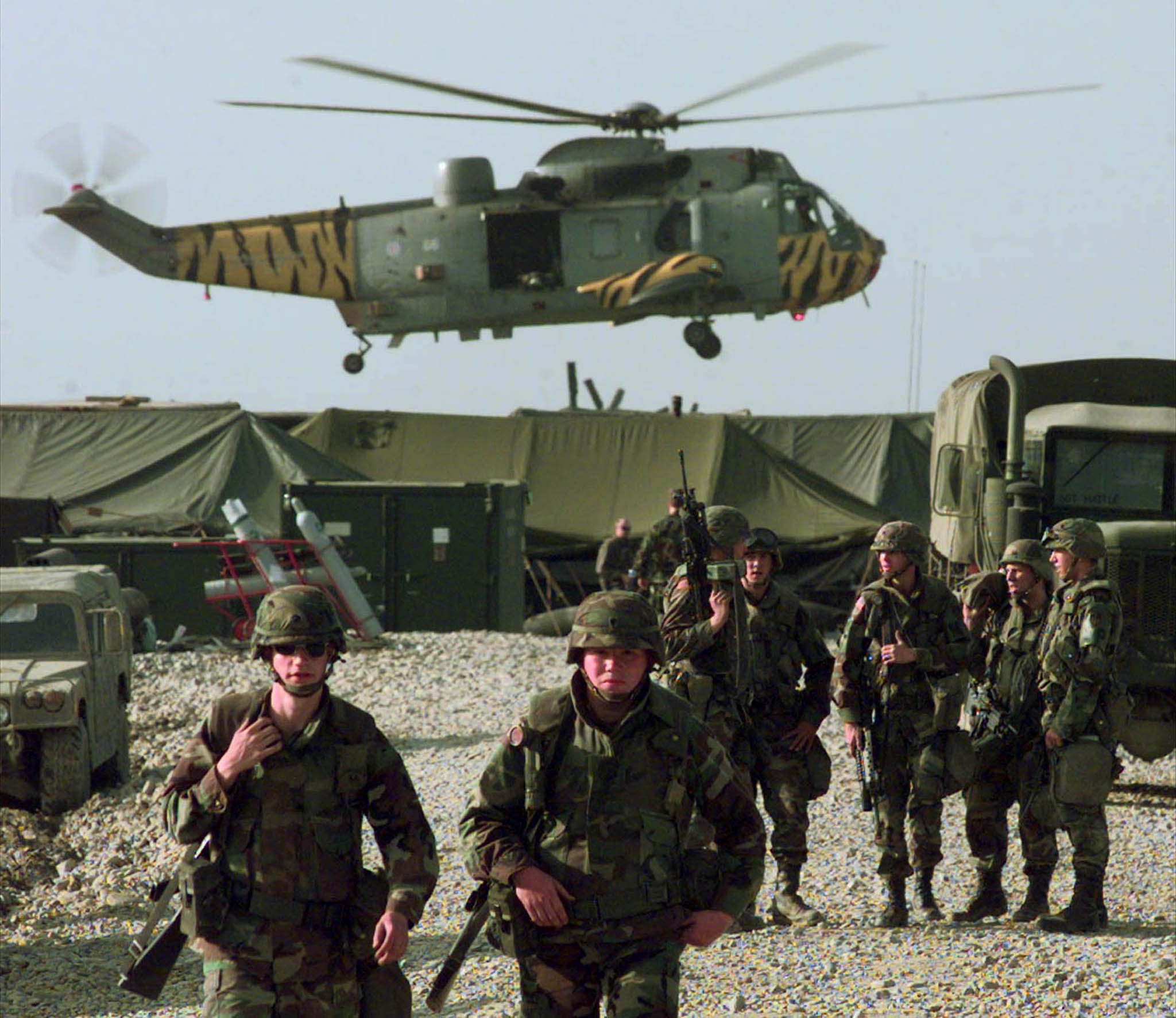 A British military helicopter, painted with tiger stripes, lands near the U.S. Army camp at the Tirana, Albania airbase, Friday, April 30, 1999.