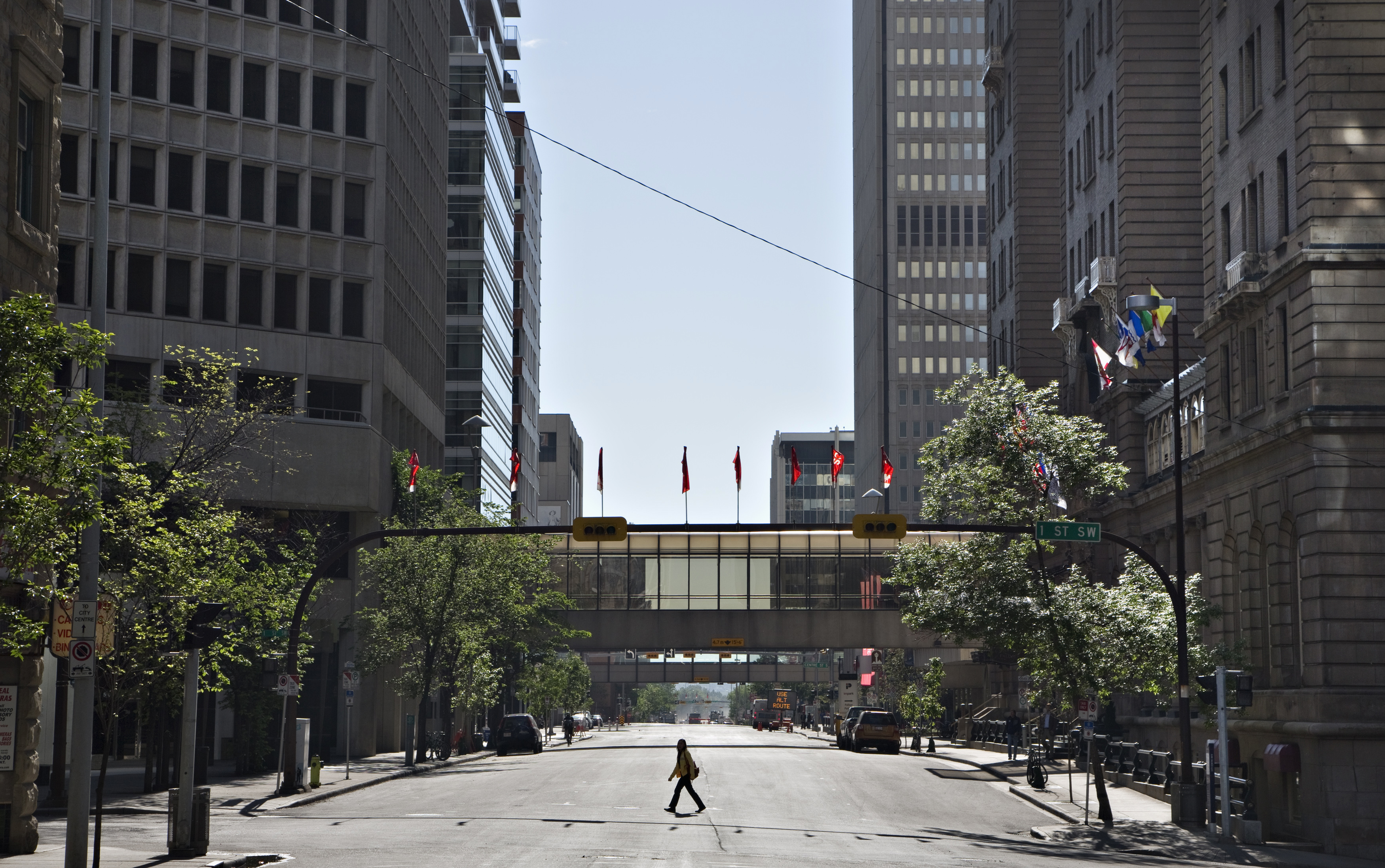A woman crosses an empty downtown street in Calgary, Alberta