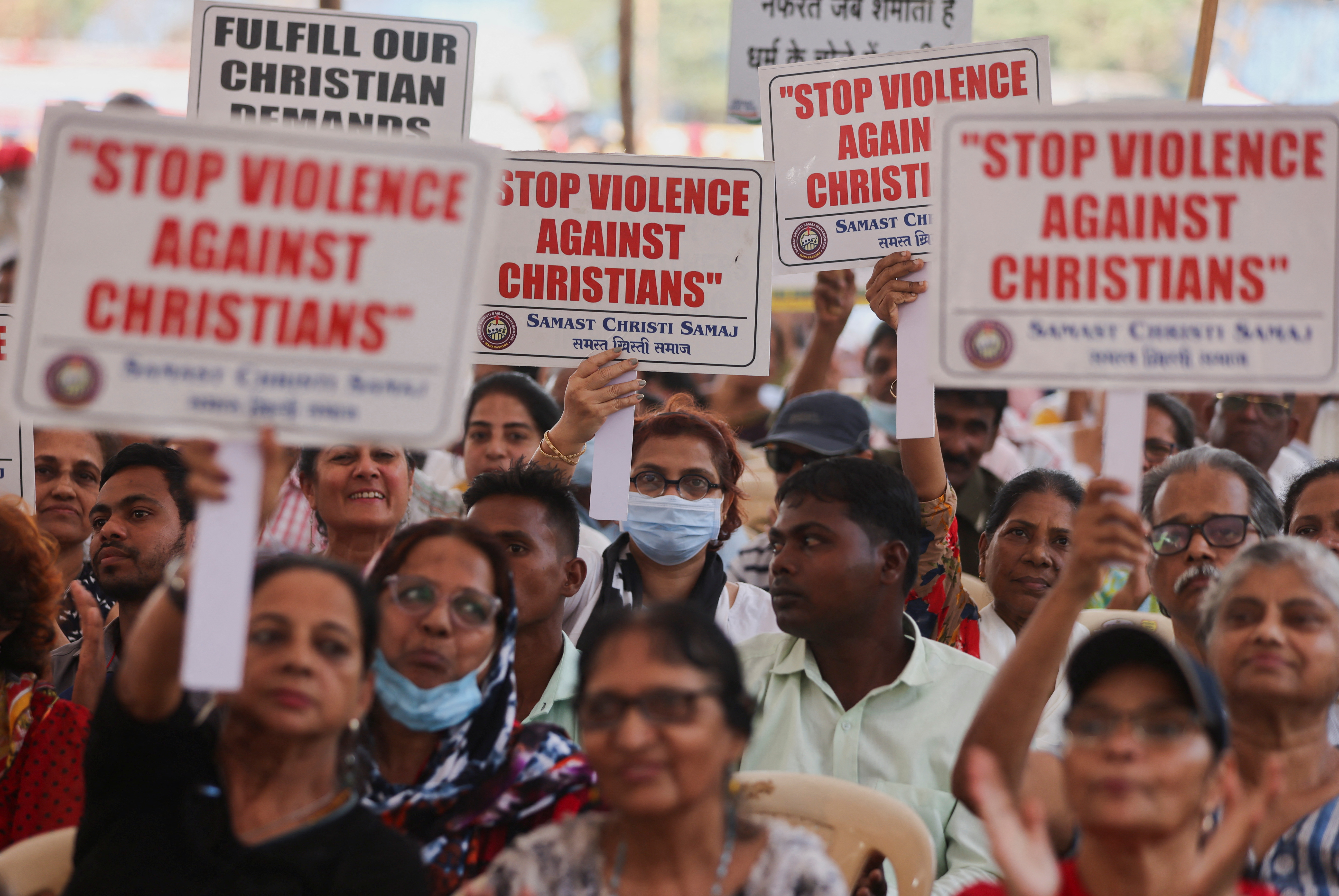 People hold placards during a protest against what they claim are attacks on the Christian community, churches and institutions across India at a ground in Mumbai, India, April 12, 2023. REUTERS/Francis Mascarenhas
