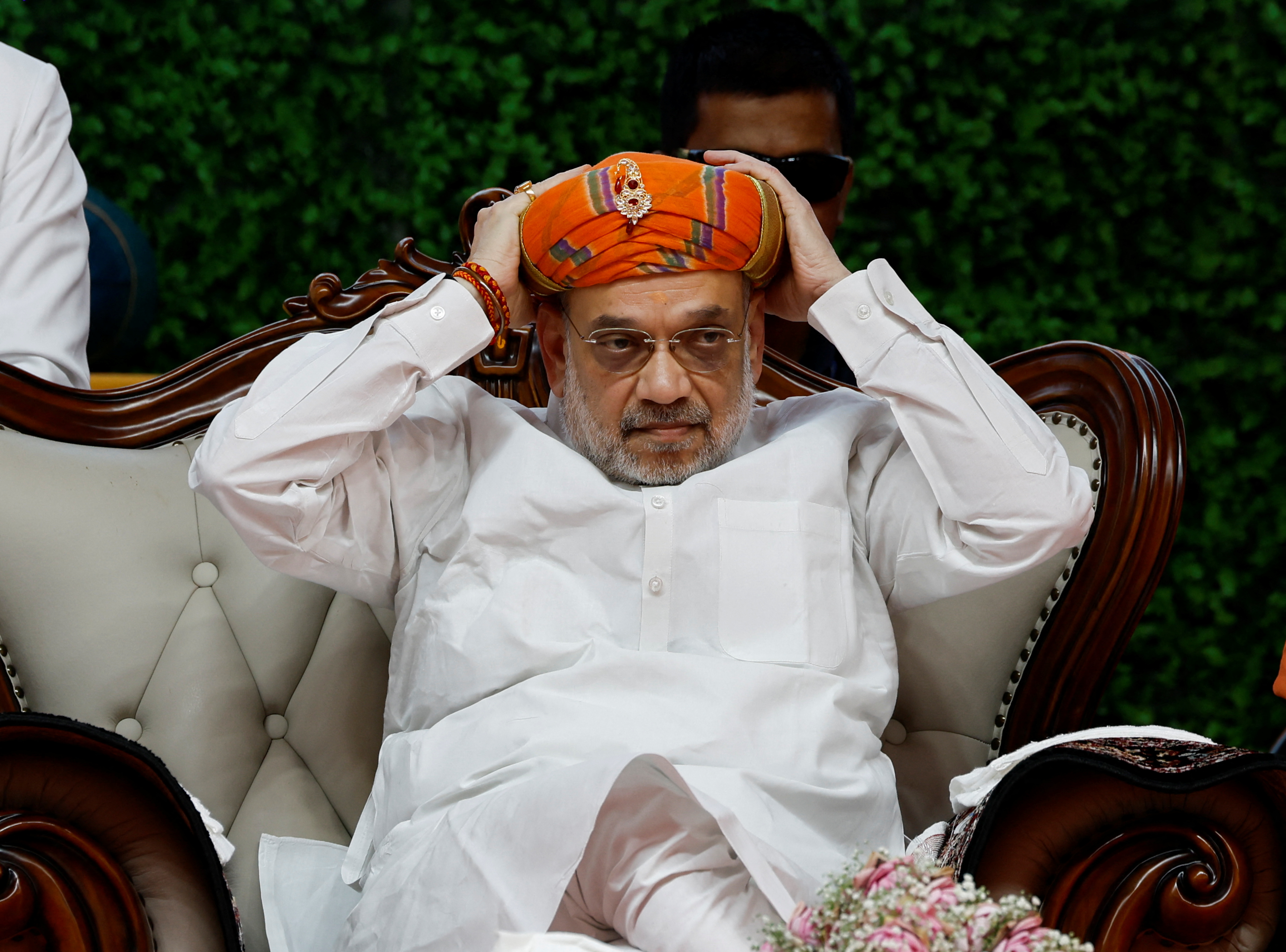 India's Home Minister Amit Shah adjusts his turban during an inauguration ceremony of Gopalanand Swami Yatrik Bhavan at a temple premises in Salangpur, in the western state of Gujarat, India, October 31, 2024. REUTERS/Amit Dave