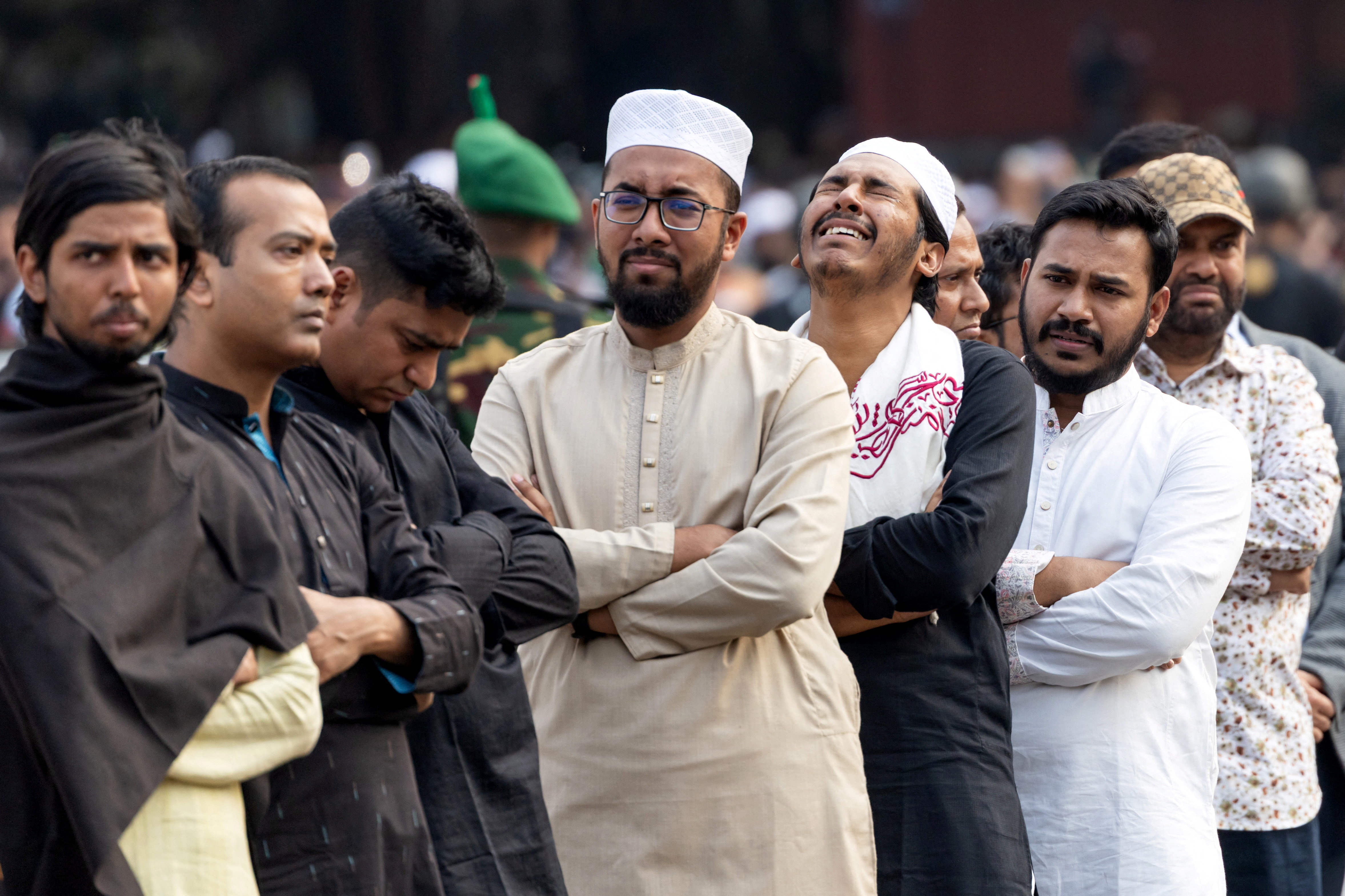 People reacts as they attend the funeral prayer for Sharif Osman Hadi, a student leader, who died after being shot in the head, at Manik Mia Avenue, in Dhaka, Bangladesh, December 20, 2025. REUTERS/Stringer