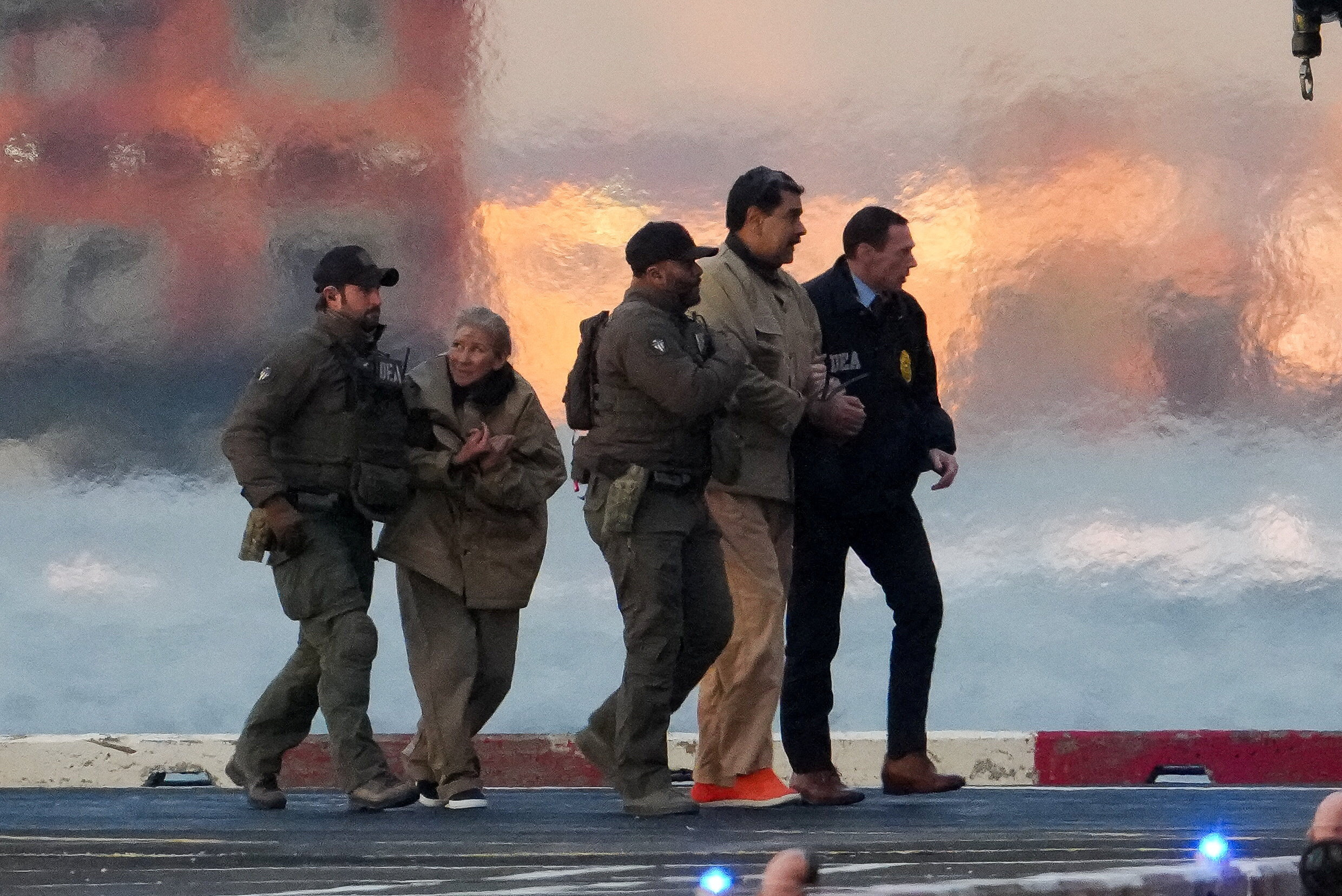 Law enforcement officials move captured Venezuelan President Nicolas Maduro and his wife Cilia Flores out of the helicopter, as Maduro heads towards the Daniel Patrick Manhattan United States Courthouse for an initial appearance to face U.S. federal charges including narco-terrorism, conspiracy, drug trafficking, money laundering and others in New York City, U.S., January 5, 2026