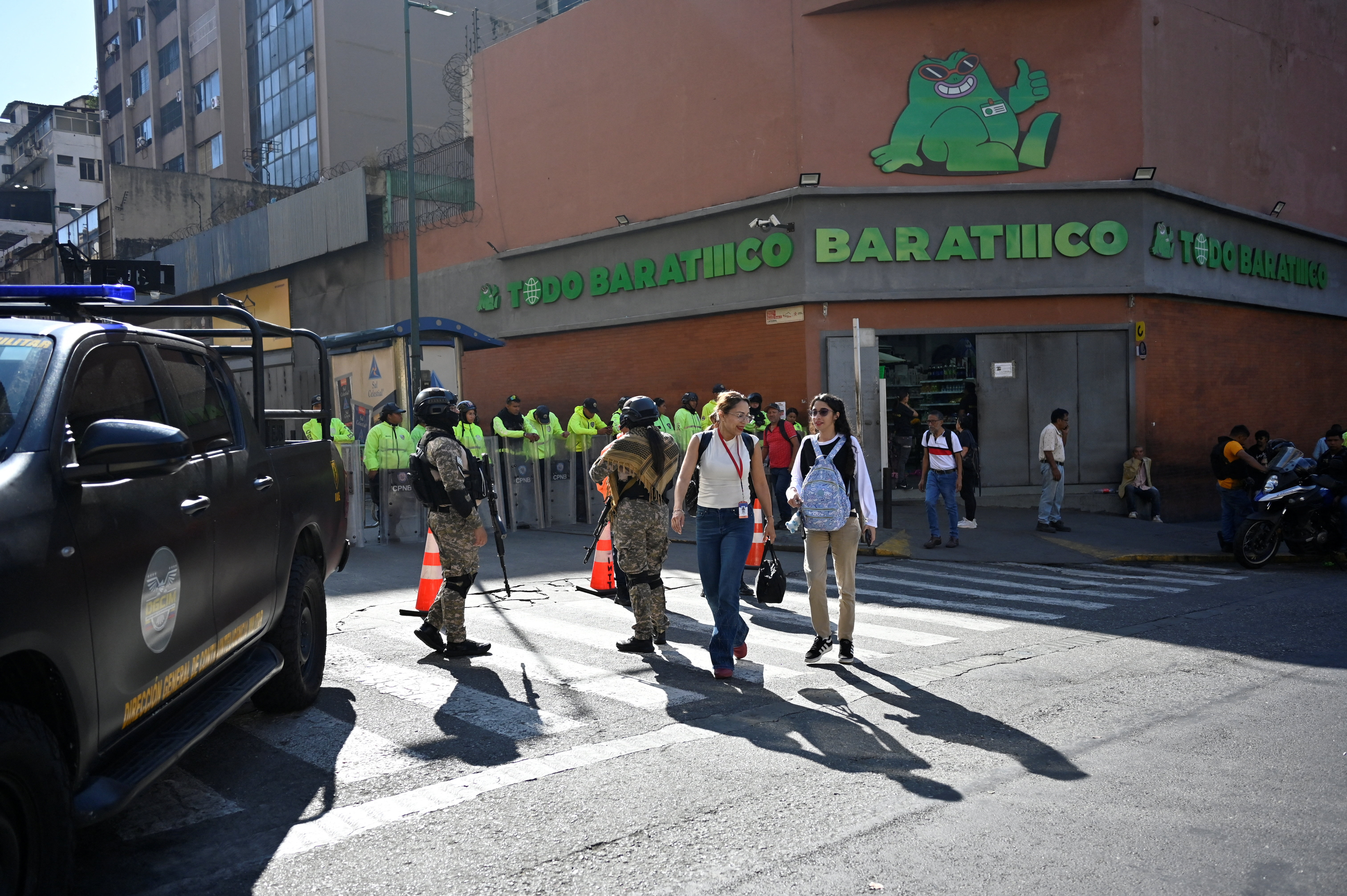 Shoppers in downtown Caracas navigate lines and increased security personnel
