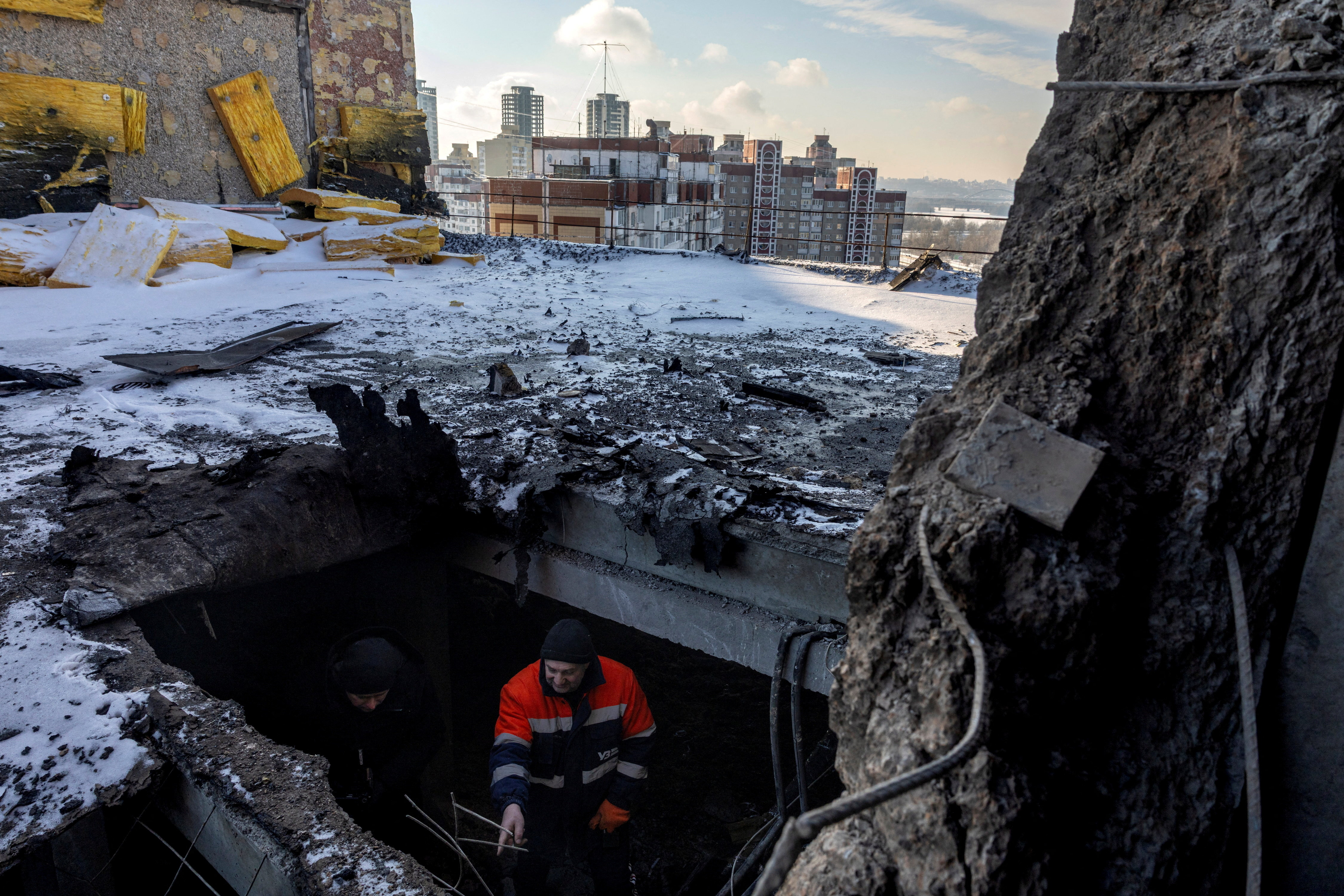A resident shows a journalist where a Russian drone struck the roof of an apartment building last night, depriving its residents of water, heat and electricity, amid Russia's attack on Ukraine, in Kyiv, Ukraine, January 10, 2026. REUTERS/Thomas Peter TPX IMAGES OF THE DAY