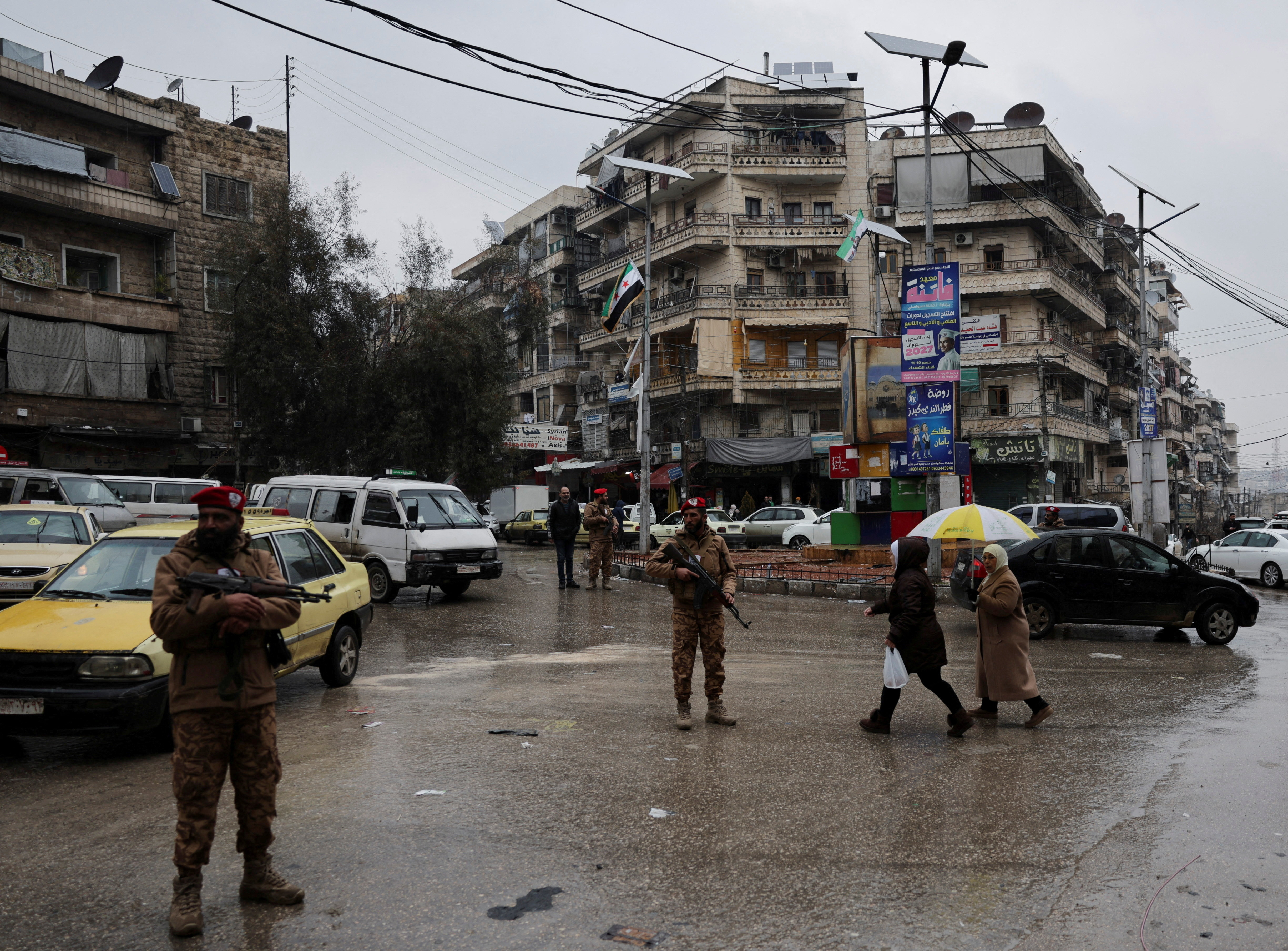 Members of general security forces stand guard in a neighbourhood.