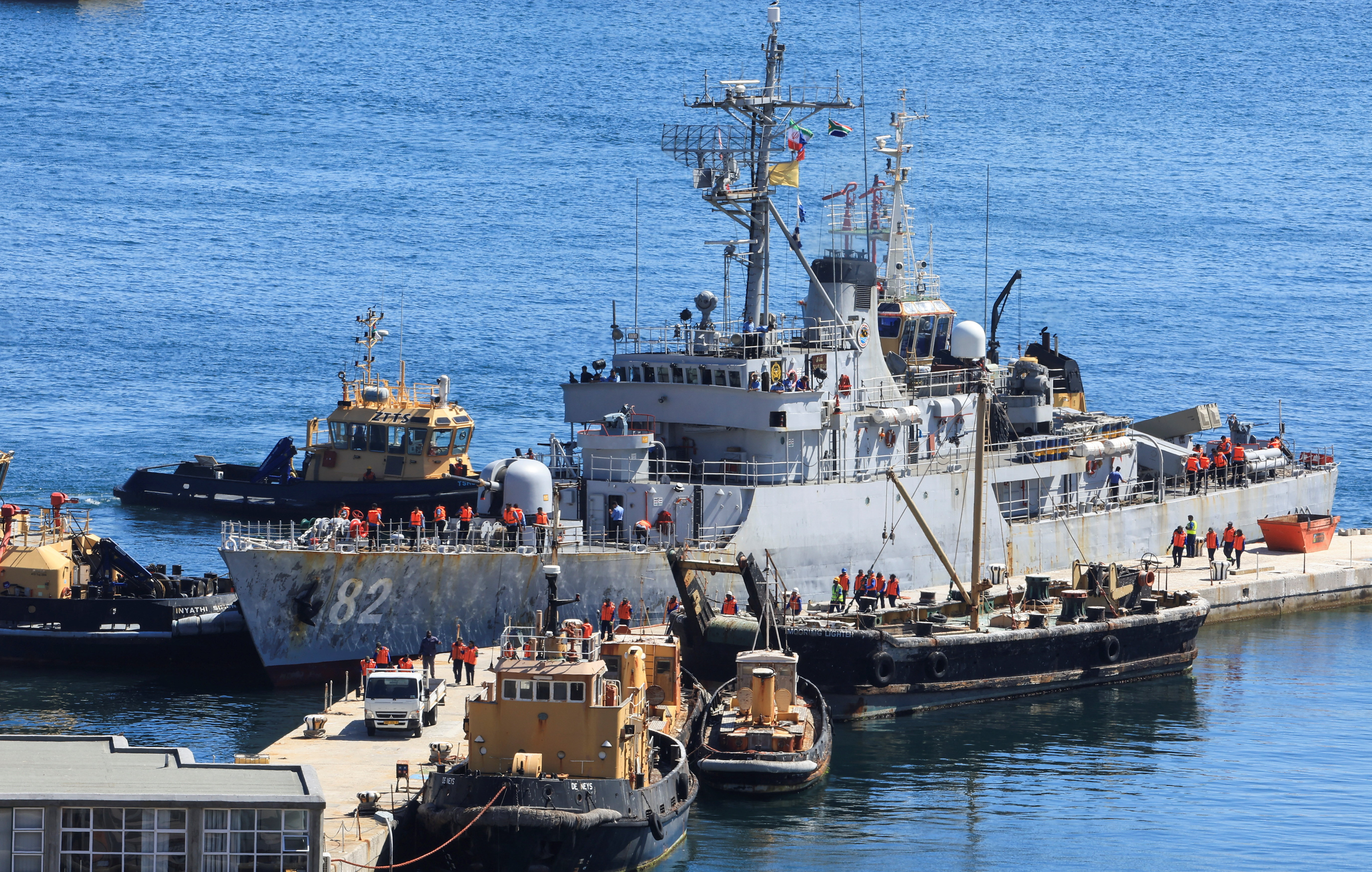 A naval vessel is seen at a port.