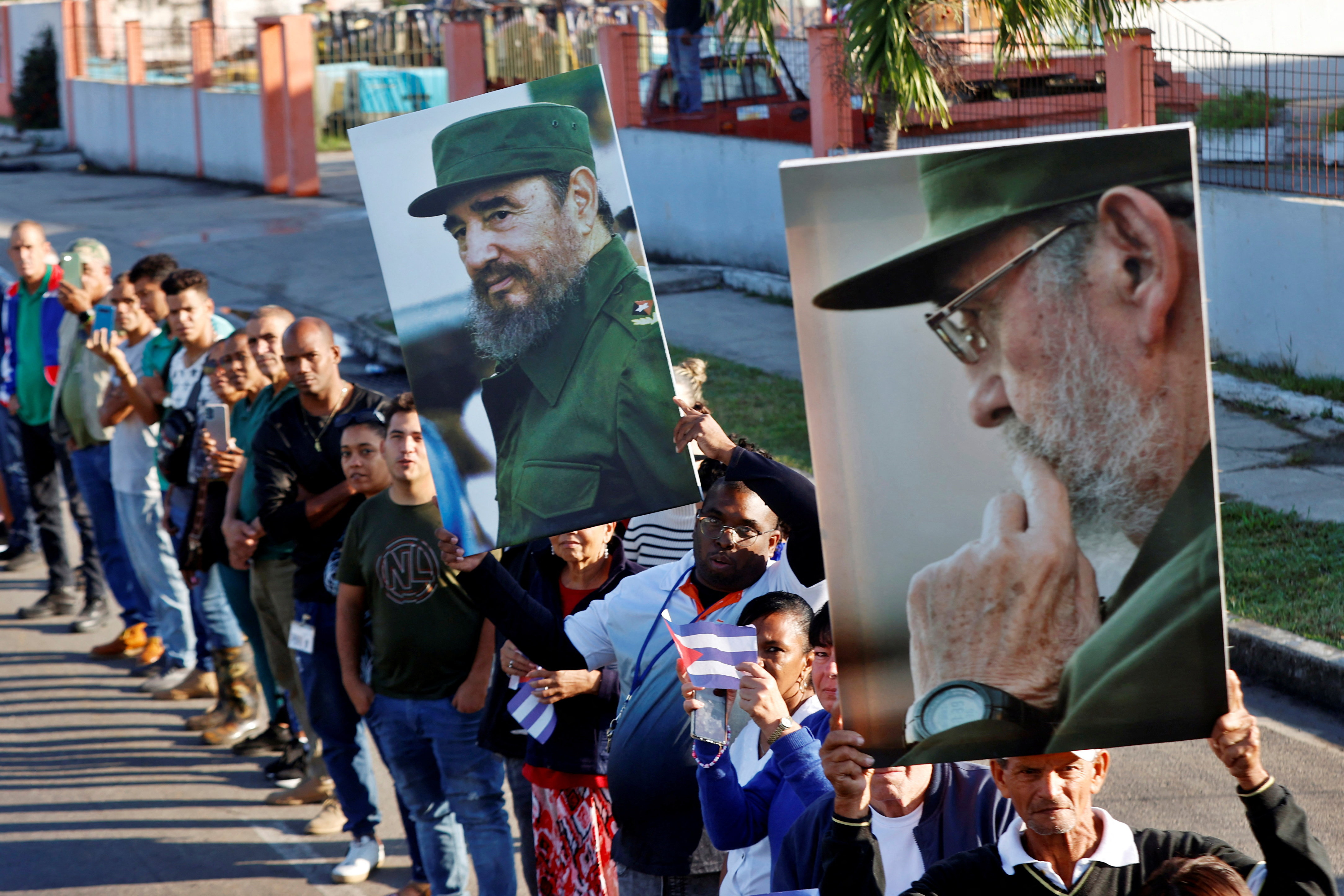People hold pictures of late Cuban President Fidel Castro.