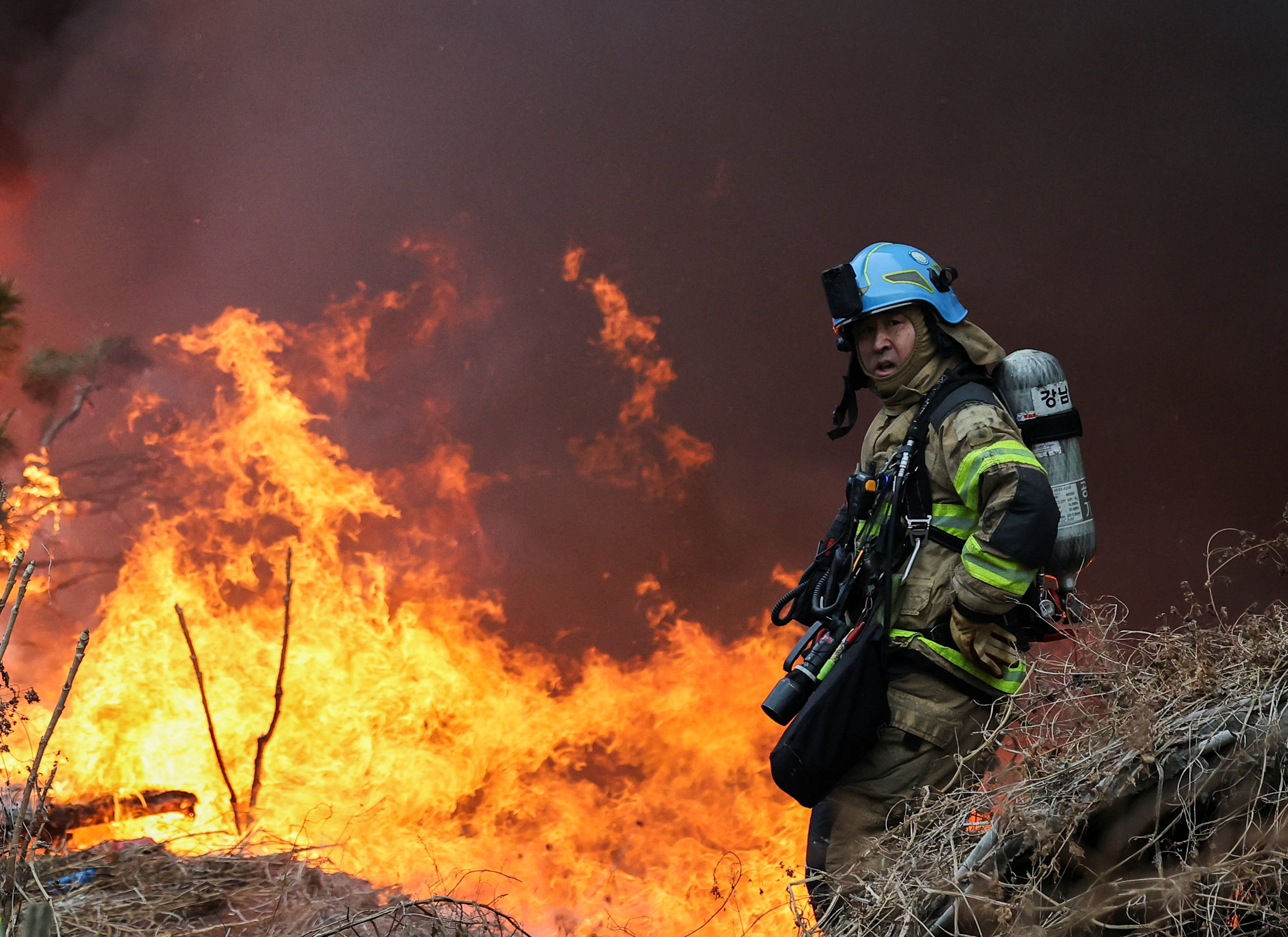 A firefighter looks on, at the scene of a fire at Guryong village, the last shantytown in the Gangnam district, in Seoul, South Korea, January 16, 2026. REUTERS/Kim Hong-ji