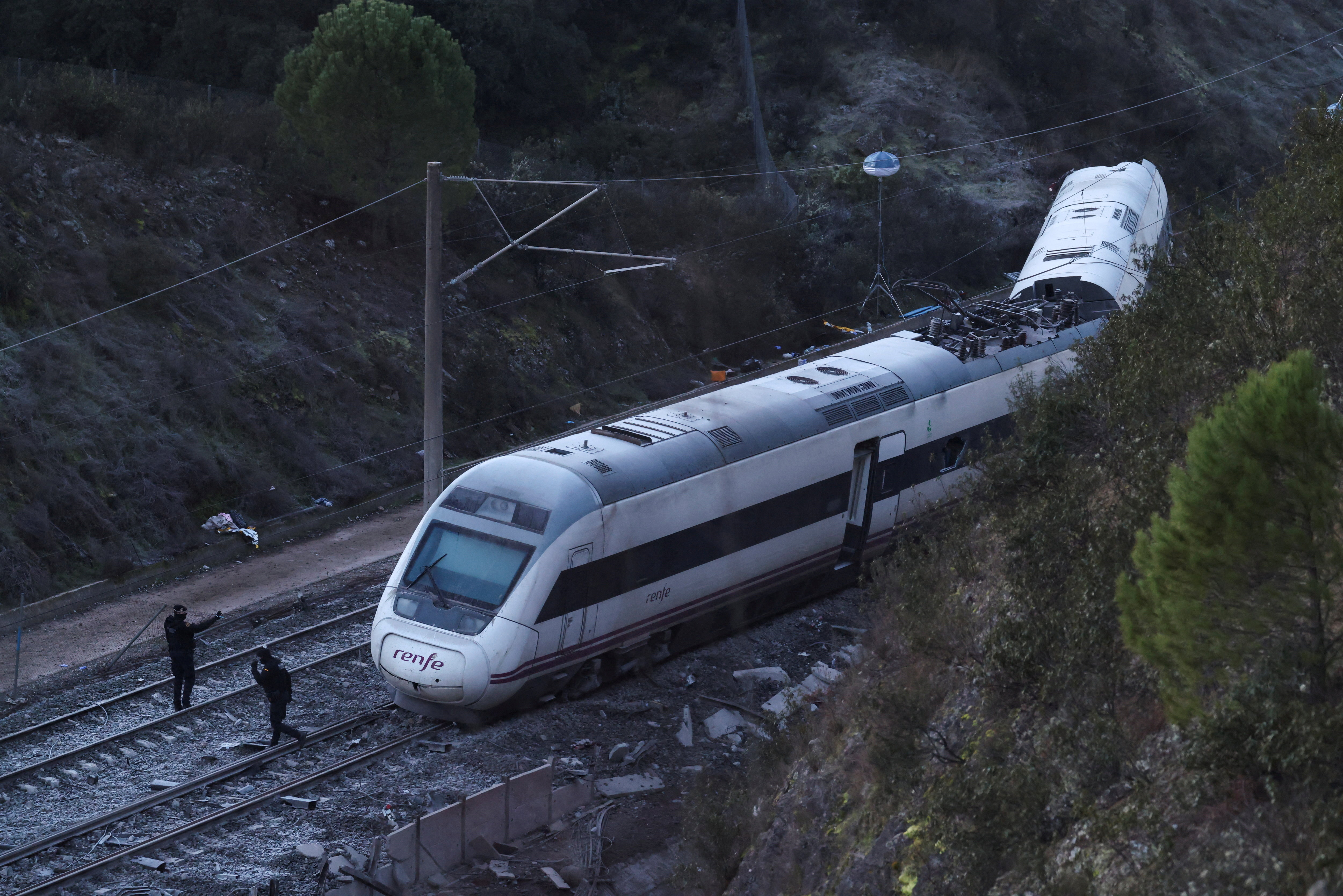 Members of the Spanish Civil Guard work next to one of the trains involved in the accident, at the site of a deadly derailment of two high-speed trains near Adamuz, in Cordoba, Spain, January 19, 2026. REUTERS/Susana Vera TPX IMAGES OF THE DAY