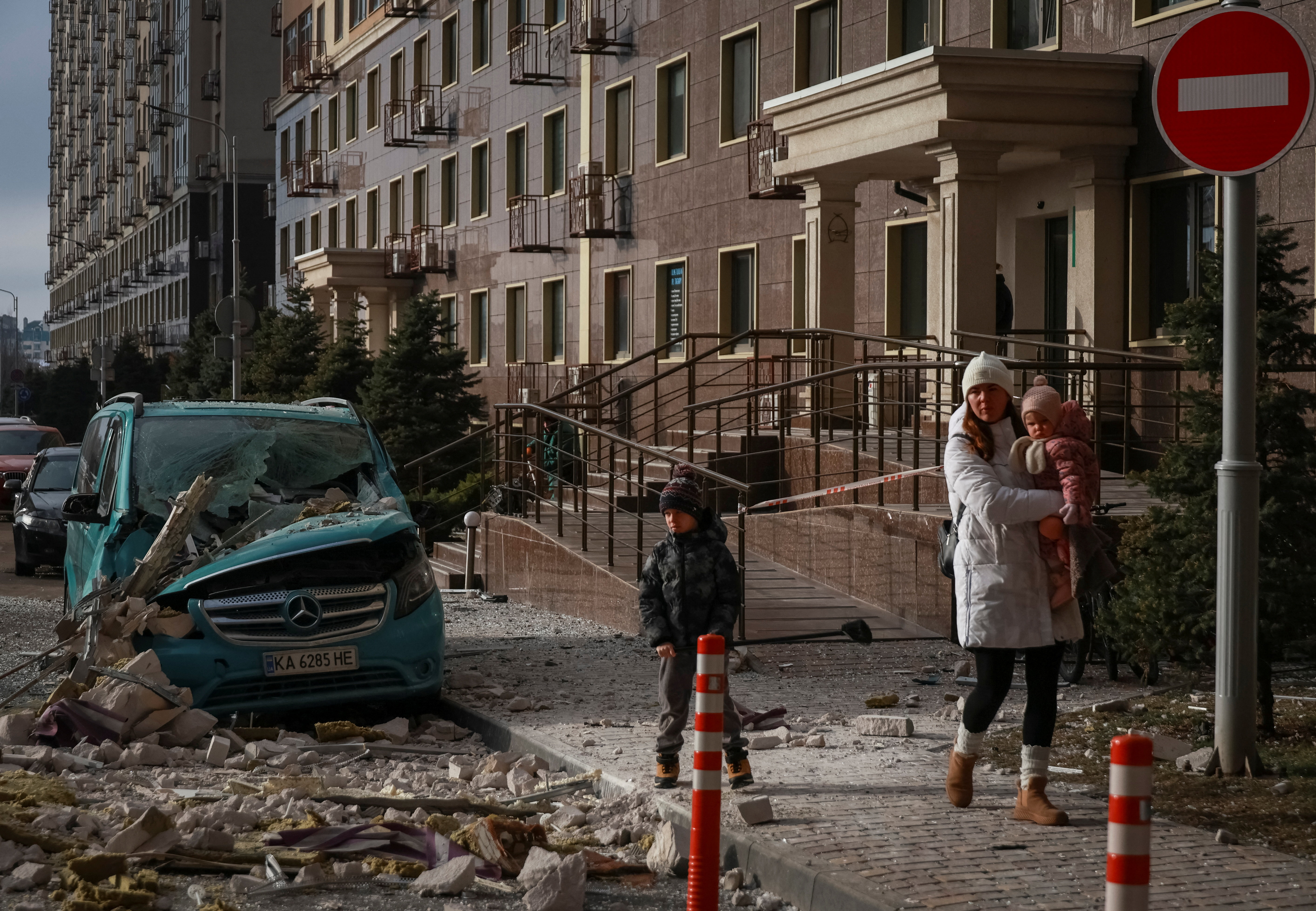 Residents walk at the site of a Russian drone strike in Odesa, Ukraine