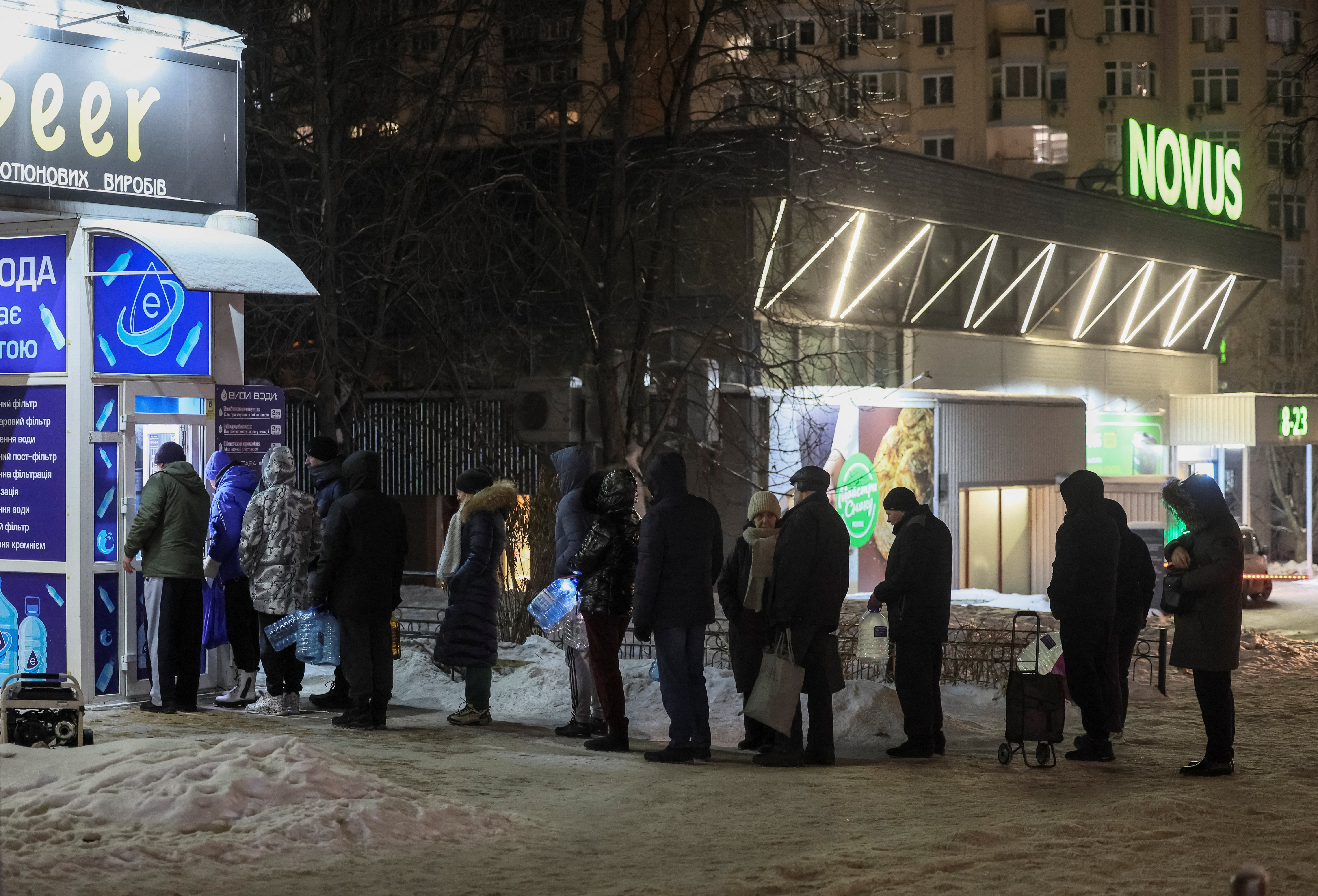 Residents stand in line to fill up bottles with fresh drinking water during a power blackout after critical civil infrastructure was hit by recent Russian missile and drone attacks, amid Russia's attack on Ukraine, in Kyiv, Ukraine January 24, 2026. REUTERS/Gleb Garanich
