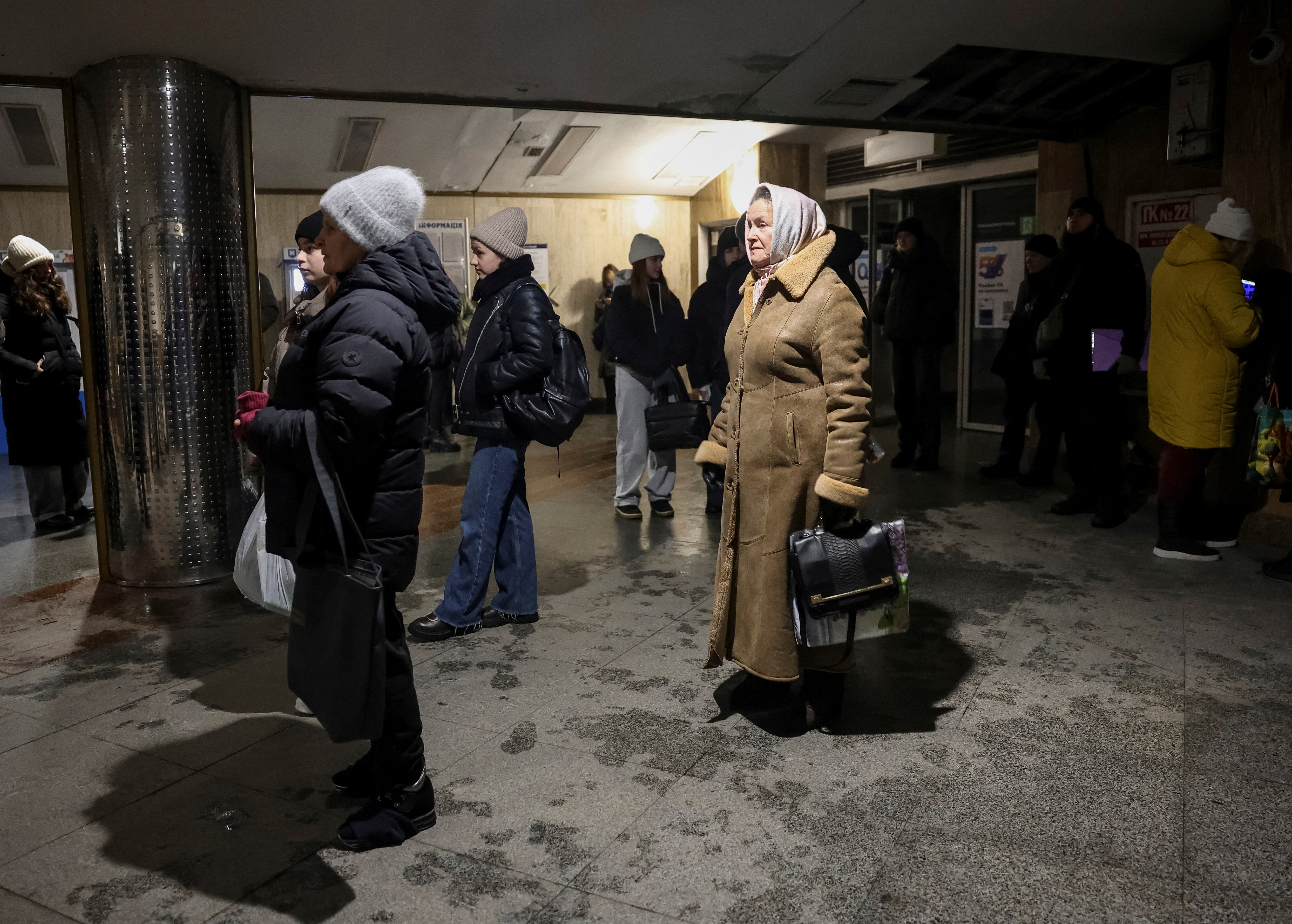 People stand at an entrance to a metro station as trains have stopped running due to a blackout after previous Russian missile and drone strikes on critical infrastructure and 'emergency situation' reported by Kyiv officials, amid Russia's attack on Ukraine, in Kyiv, Ukraine January 31, 2026. REUTERS/Anatolii Stepanov