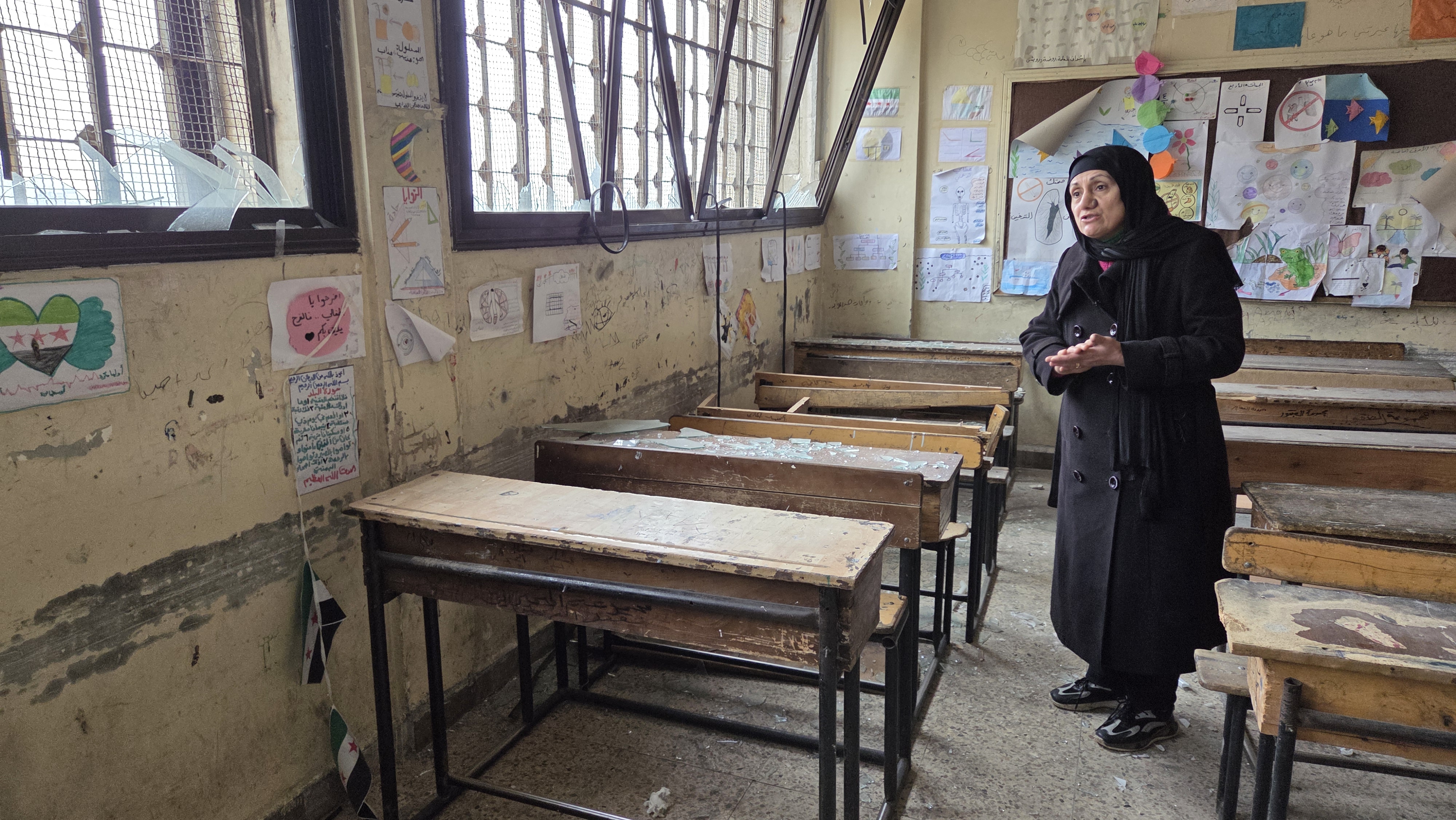 Woman walks in an empty classroom