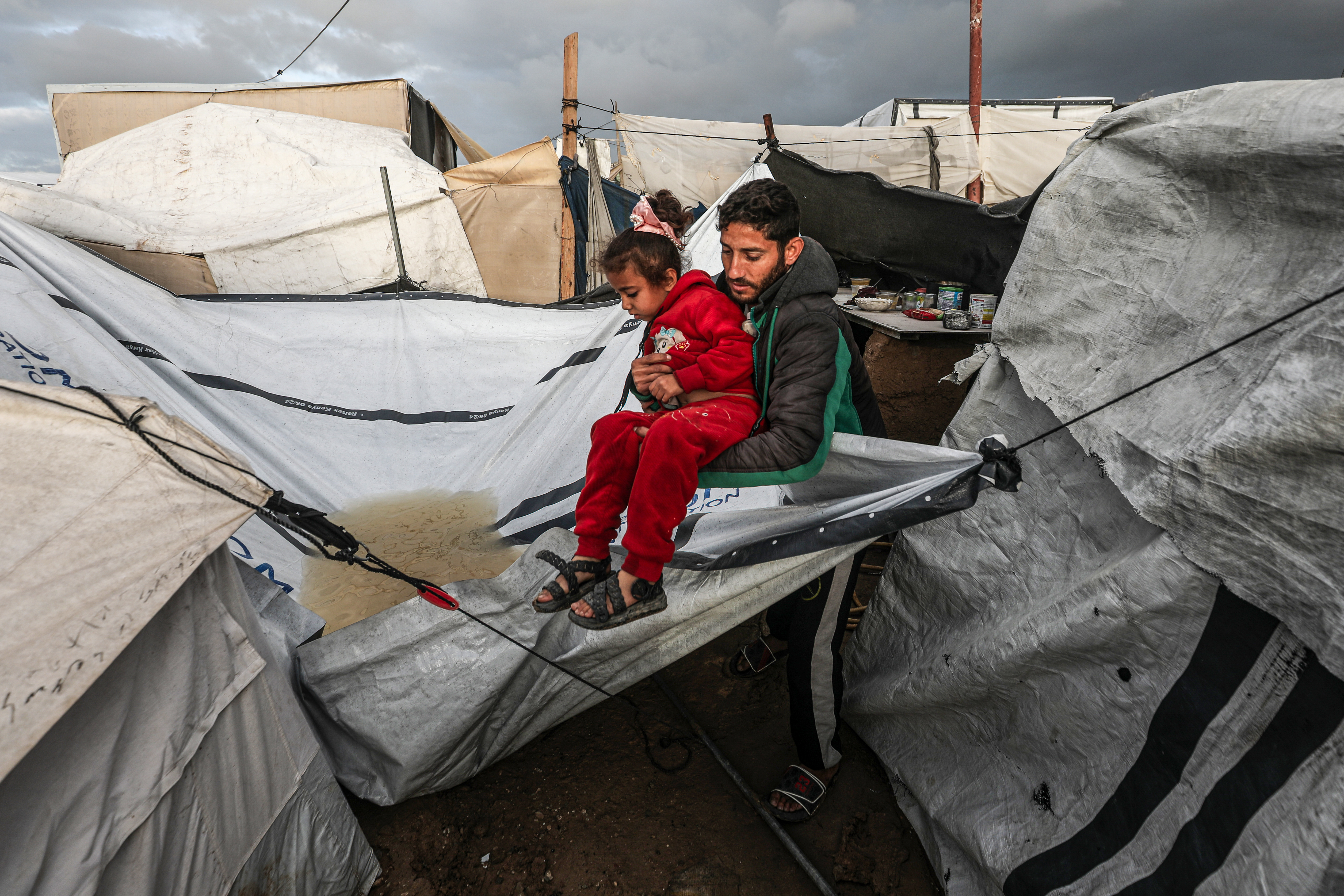 Palestinians struggle as heavy rain and storm damage their tents in the Bureij Refugee Camp