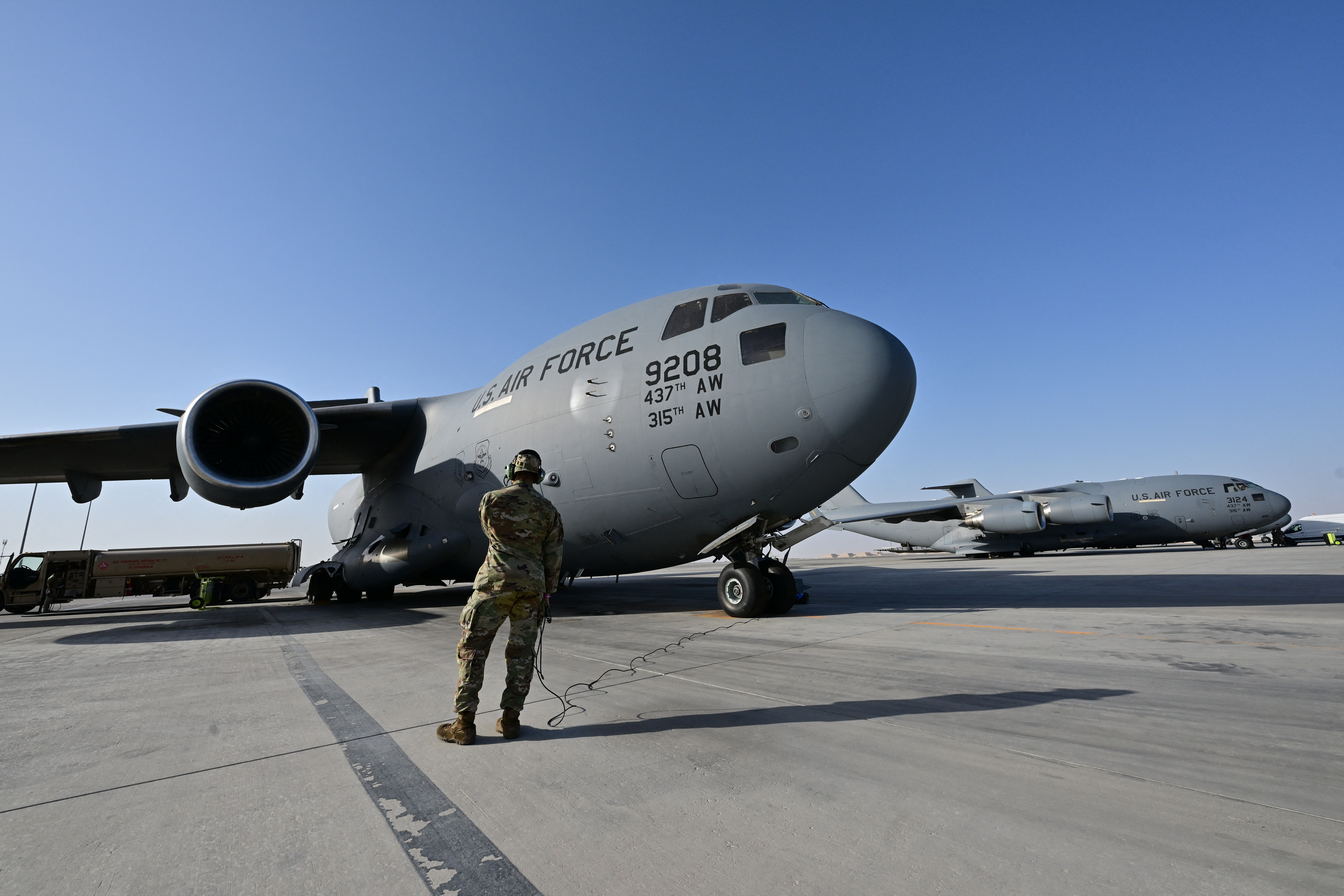 A US military transport aircraft, which will carry humanitarian aid parcels for the Gaza Strip, is pictured on the tarmac at the Al-Udeid air base southwest of Doha