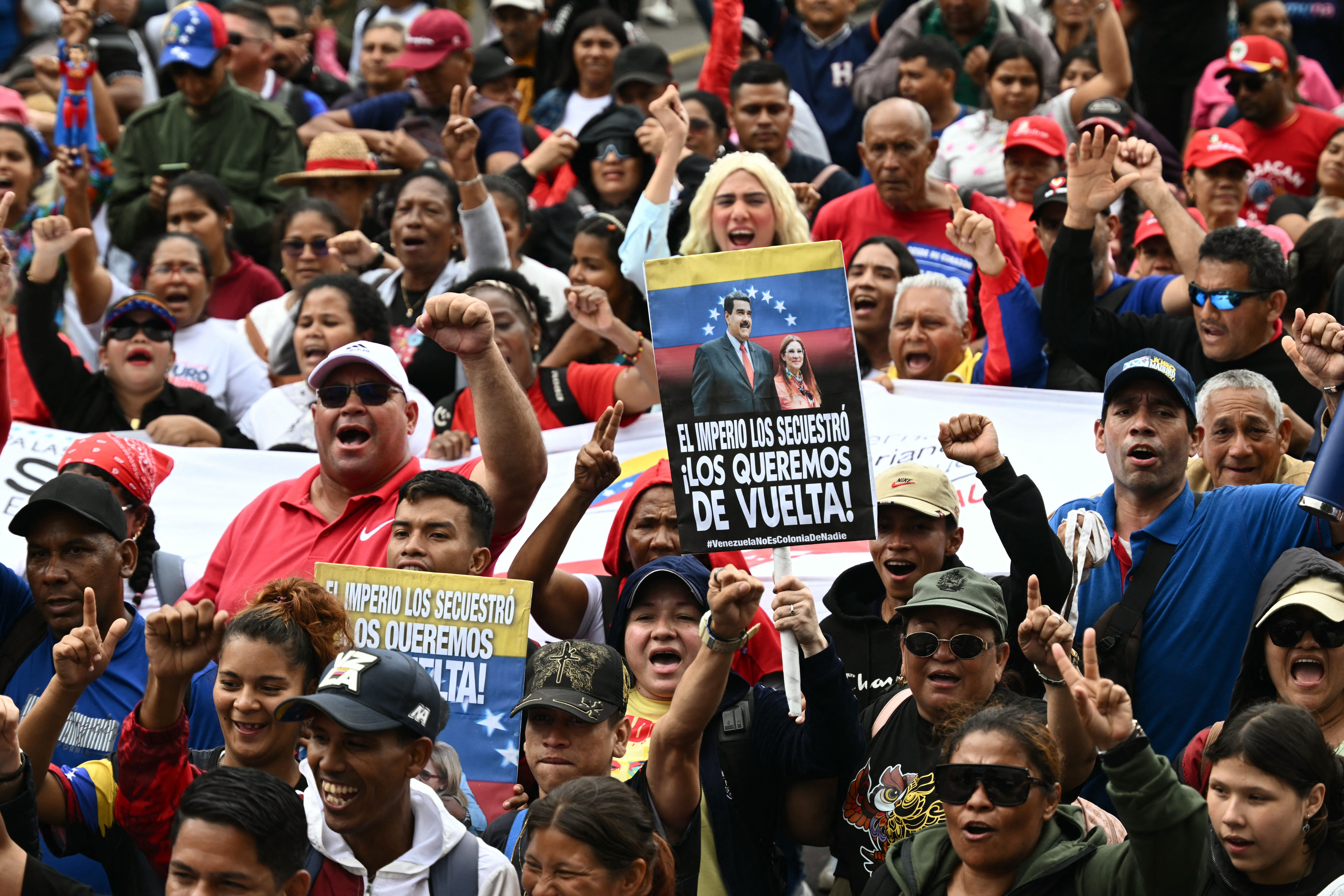 Demonstrators shout slogans during a rally in support of ousted Venezuela's President Nicolas Maduro in Caracas on January 7, 2026. US President Donald Trump's administration said on January 7, it intends to dictate the decisions of Venezuela's interim leaders and control the country's oil sales "indefinitely" after toppling Nicolas Maduro. (Photo by RONALDO SCHEMIDT / AFP)
