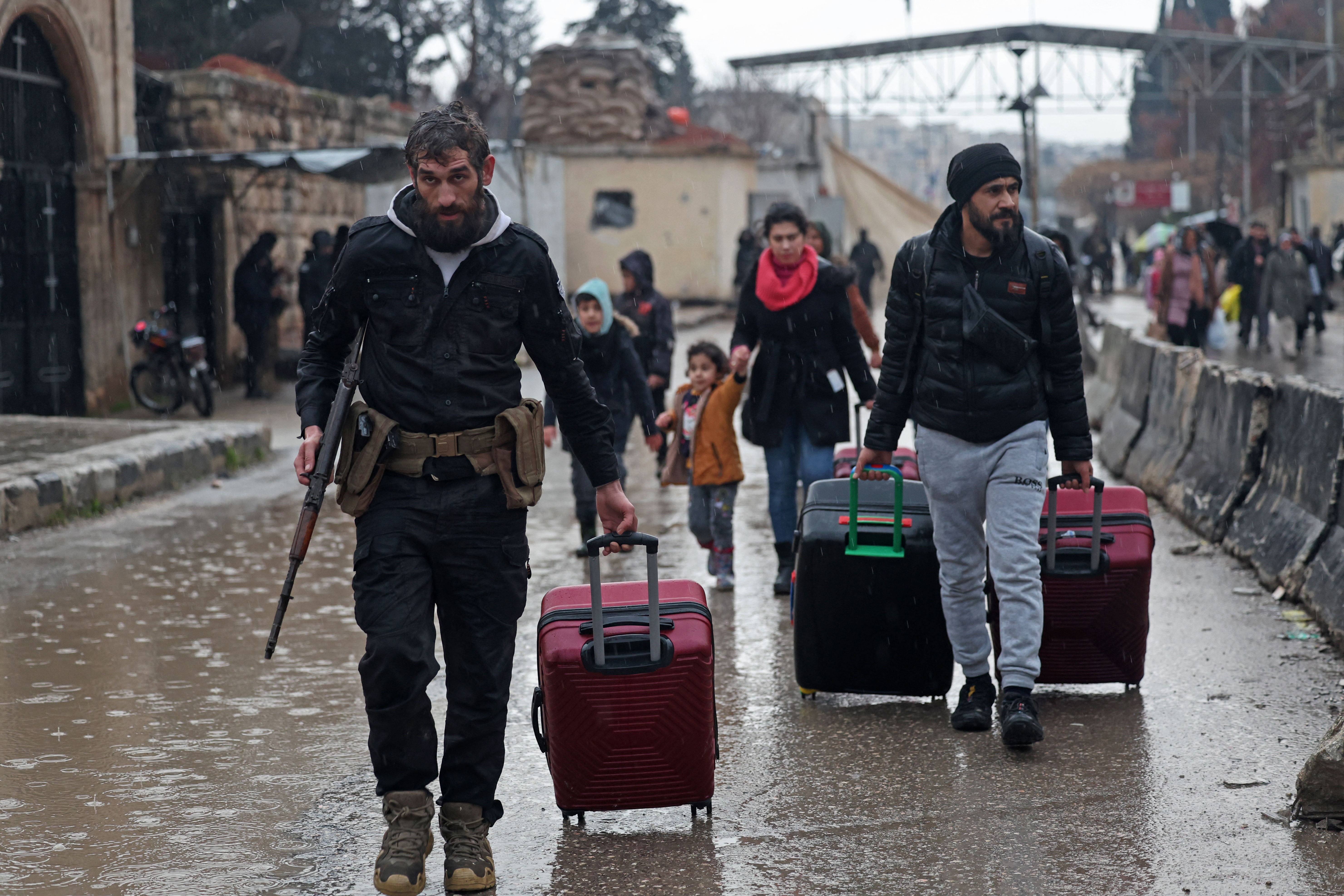 Residents of Aleppo's Sheikh Maqsoud area evacuate their neighbourhood after warnings from the Syrian army that called on civilians to get out of harms way, following the refusal of Kurdish fighter forces to leave Aleppo
